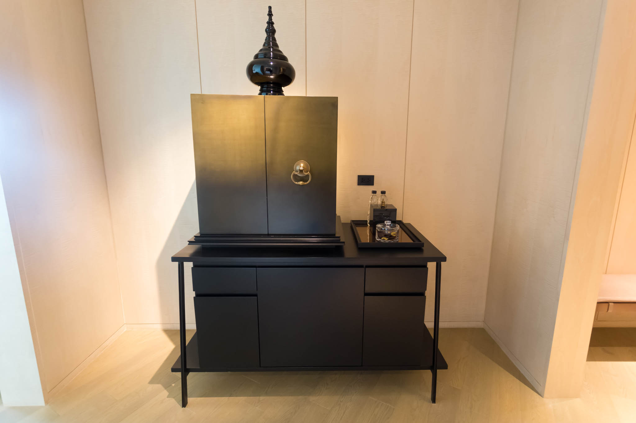a black cabinet with a black object on top