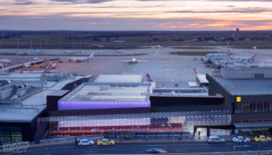 an airport with a lot of airplanes and a building