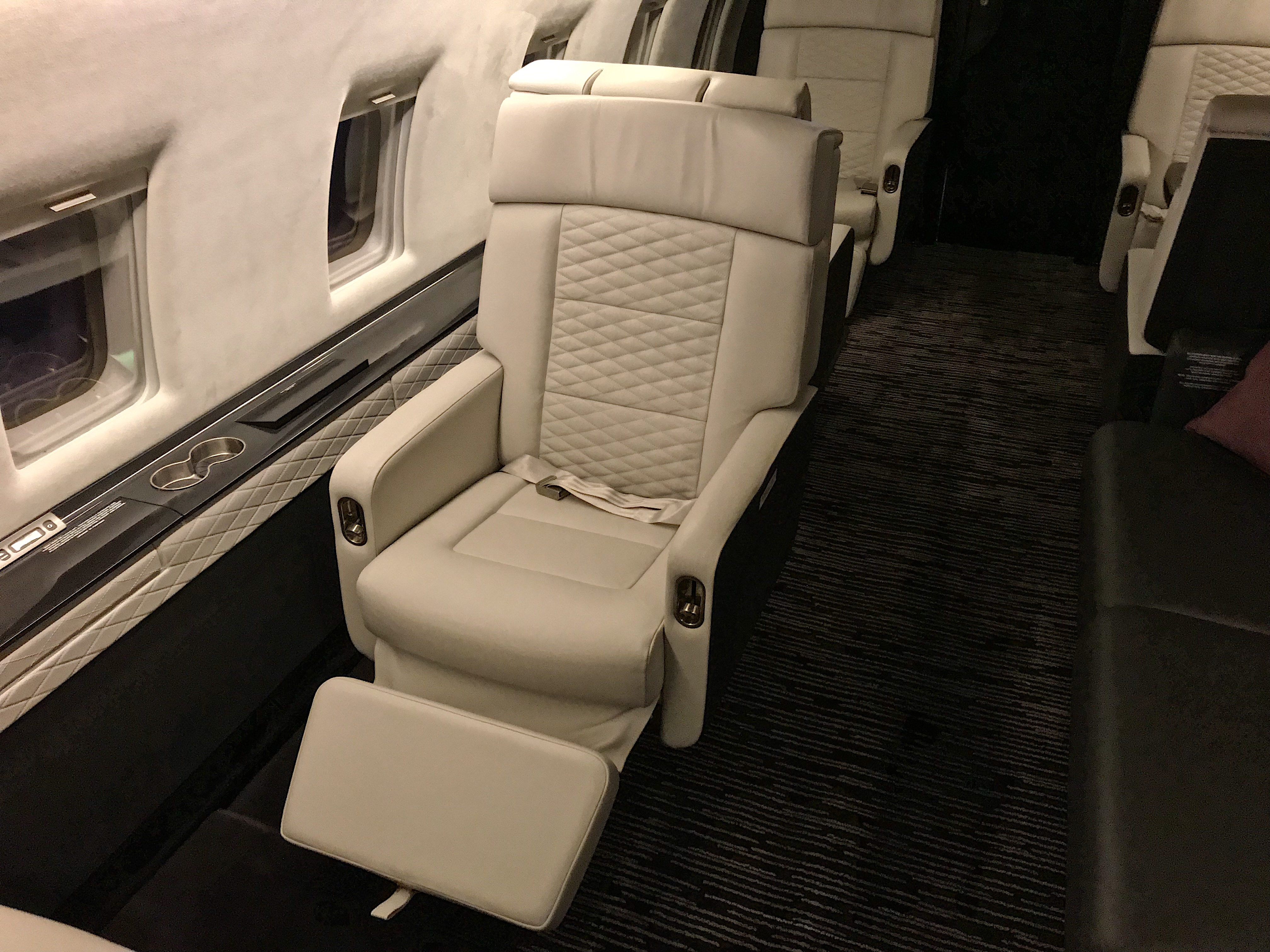 a white leather chair in a plane