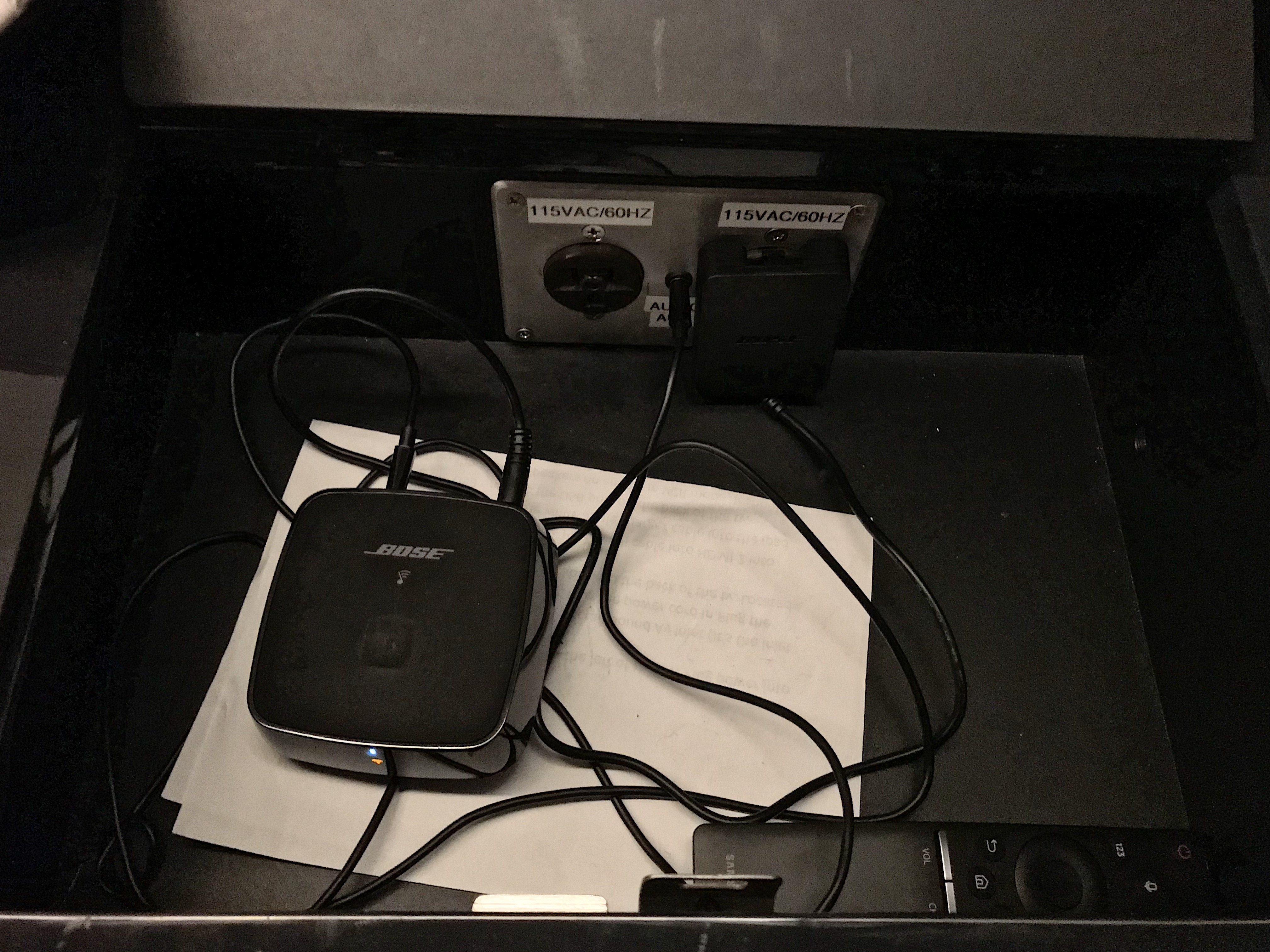 a black device with wires connected to a paper