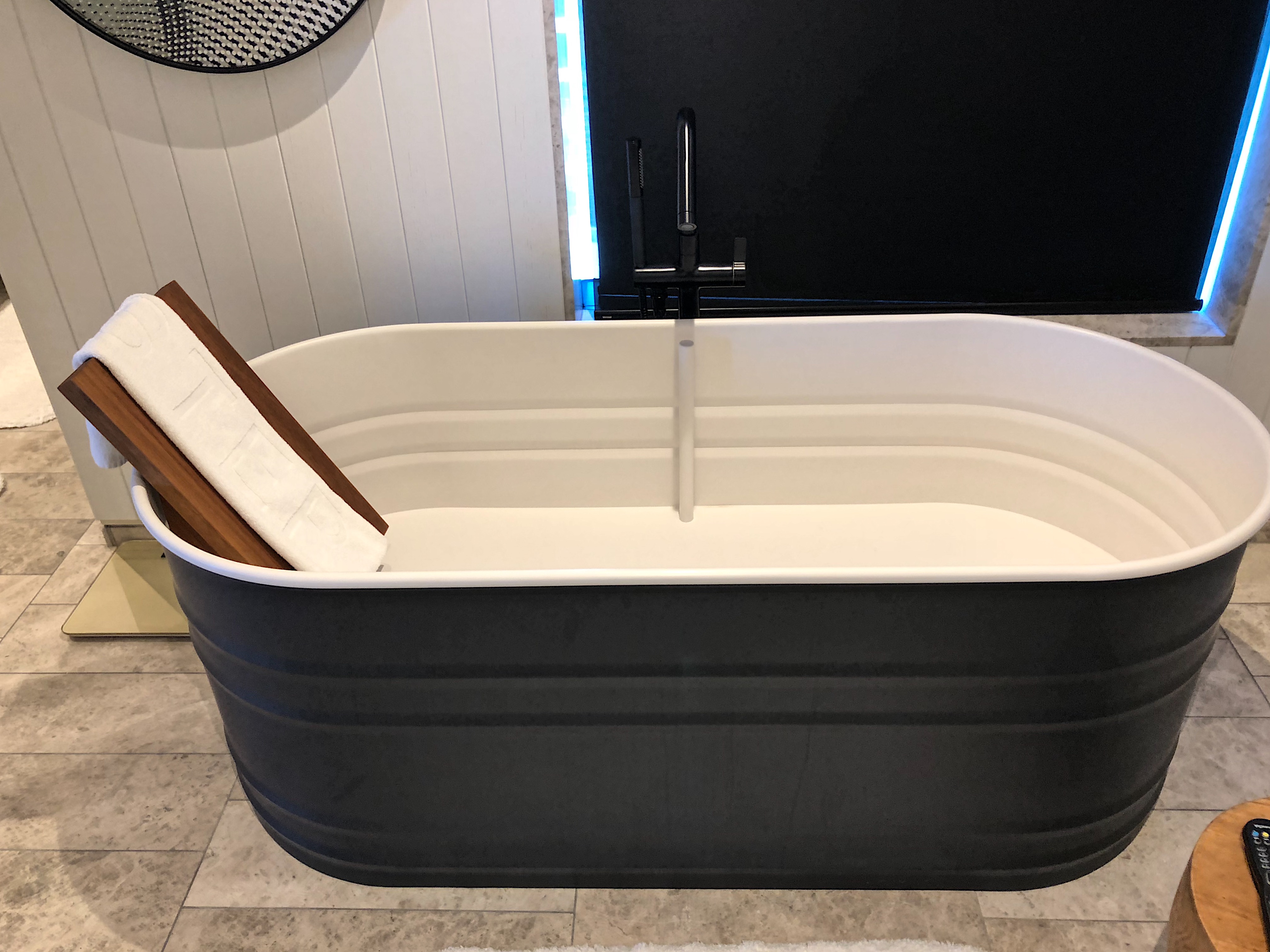 a tub with a sink and a faucet