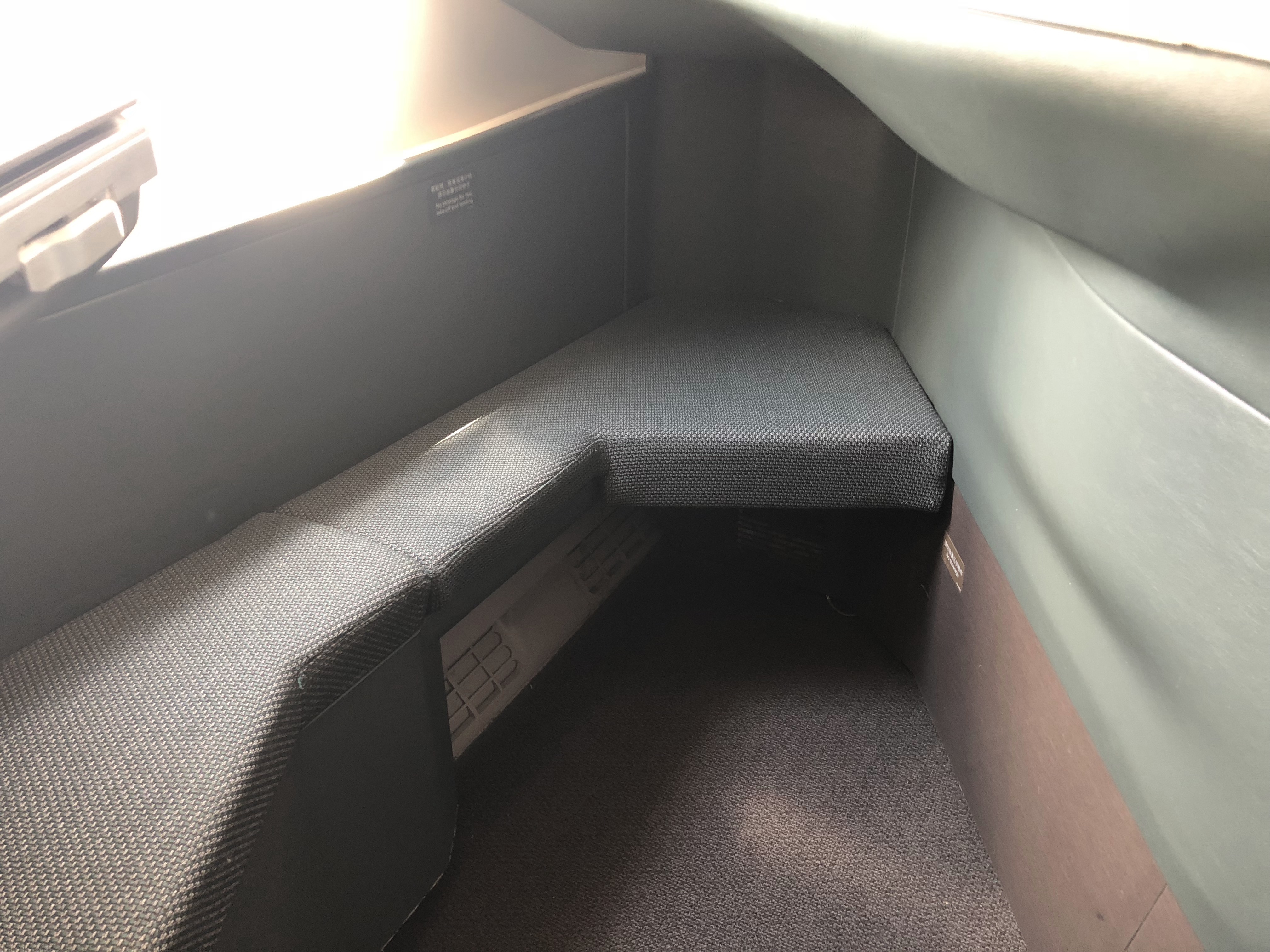 a seat in a corner of a bus