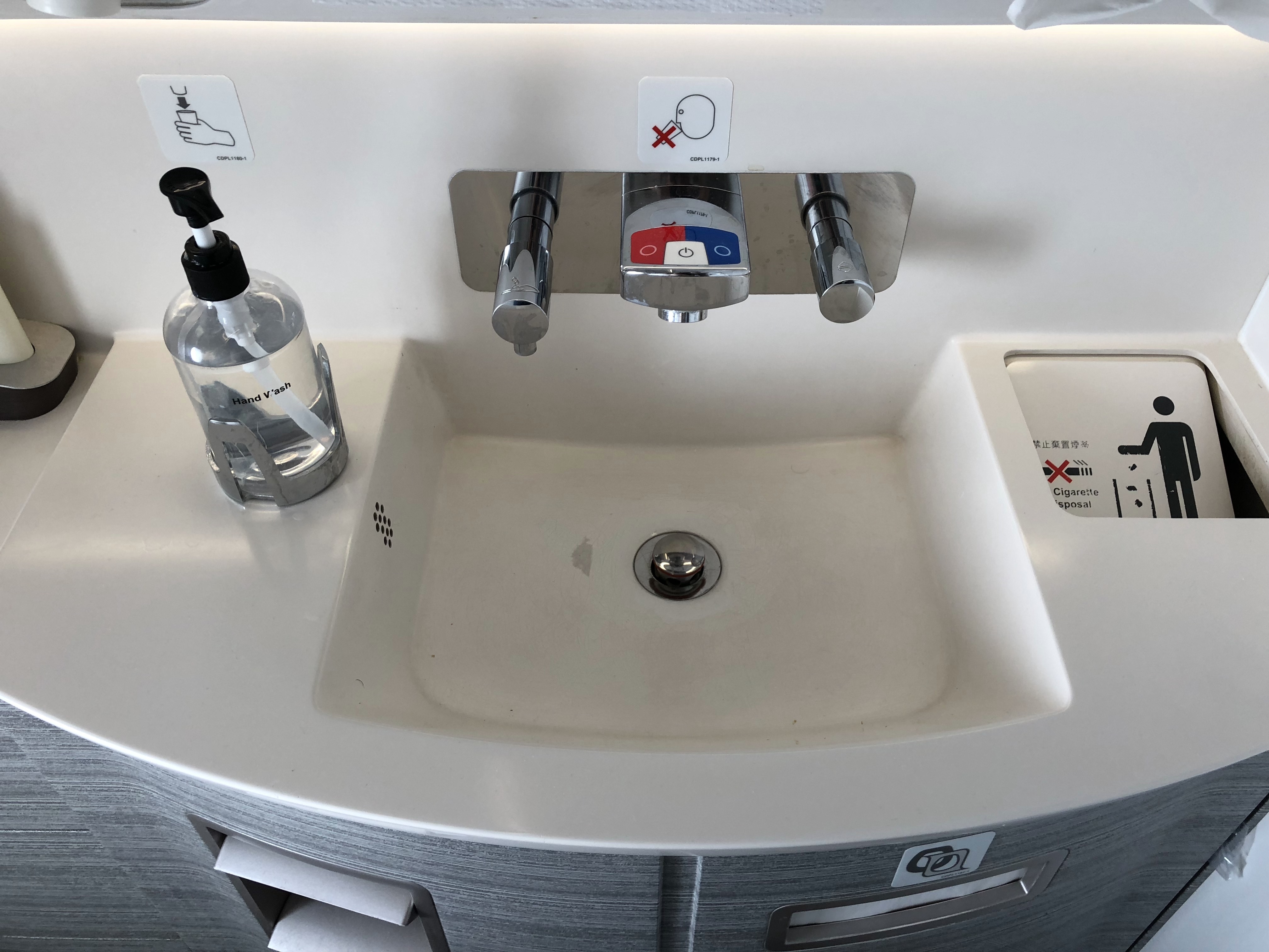 a sink with a bottle of liquid and a label