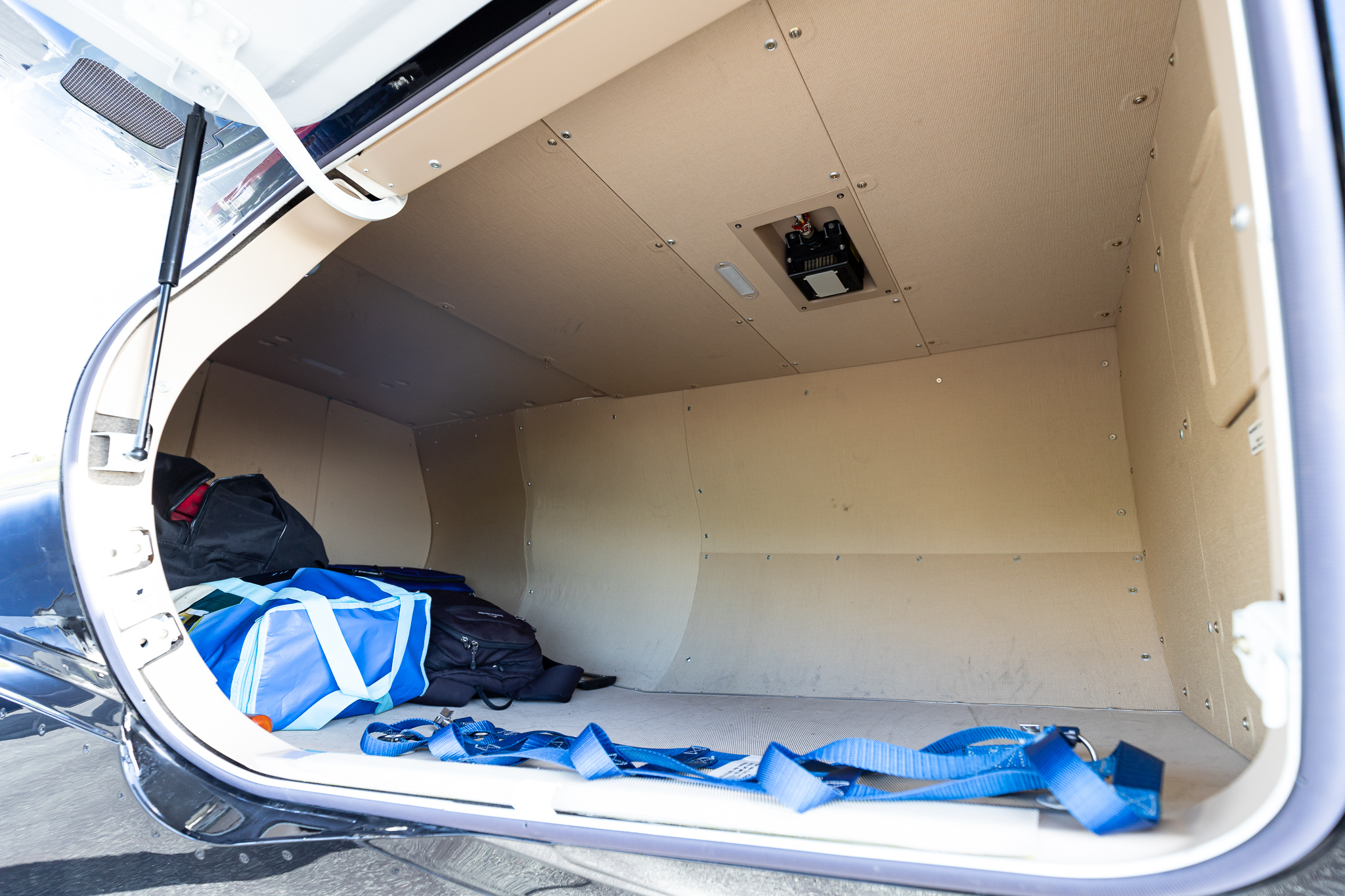 a inside of a vehicle with a blue bag and straps