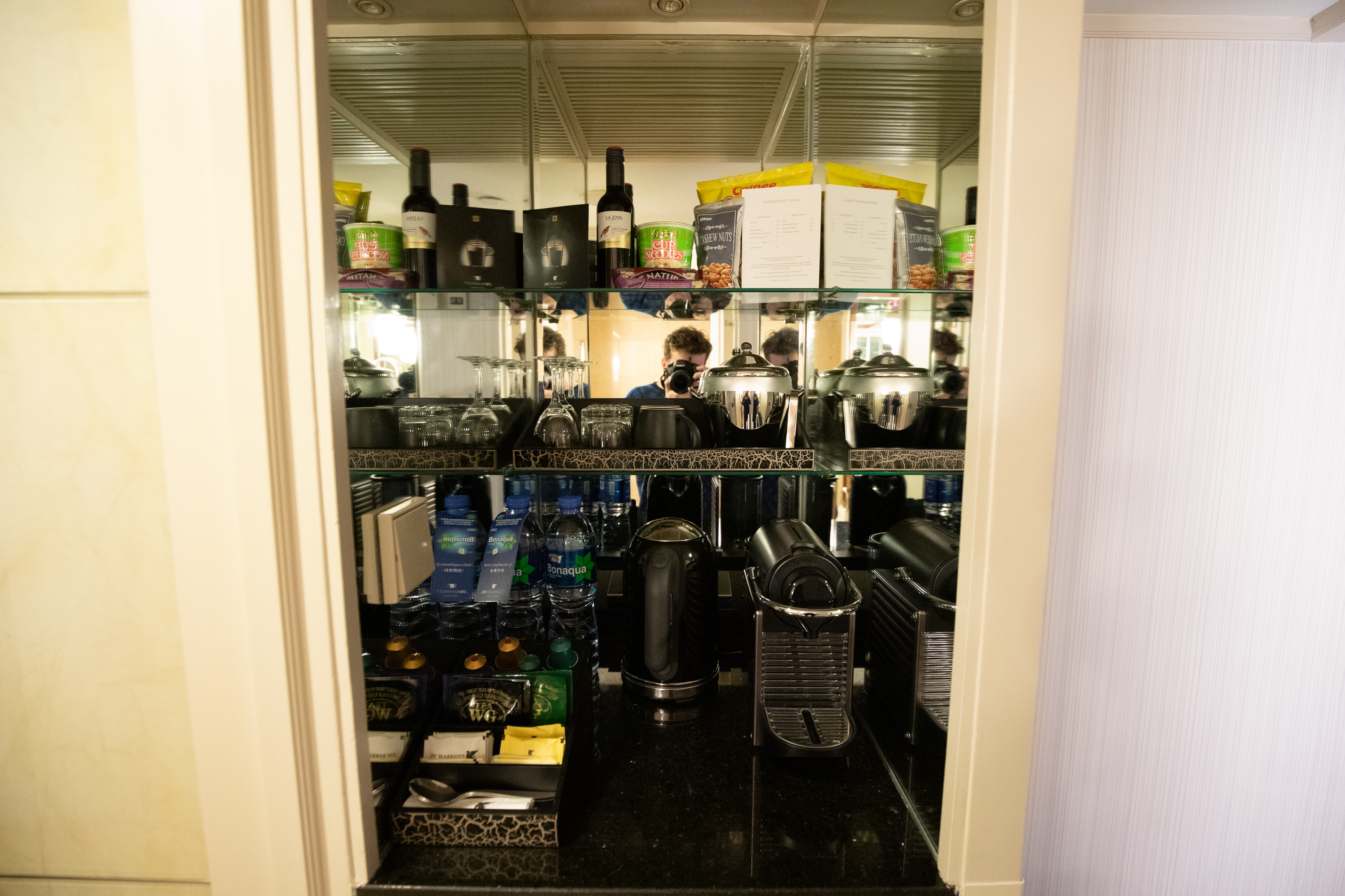 a glass shelf with a variety of kitchen appliances