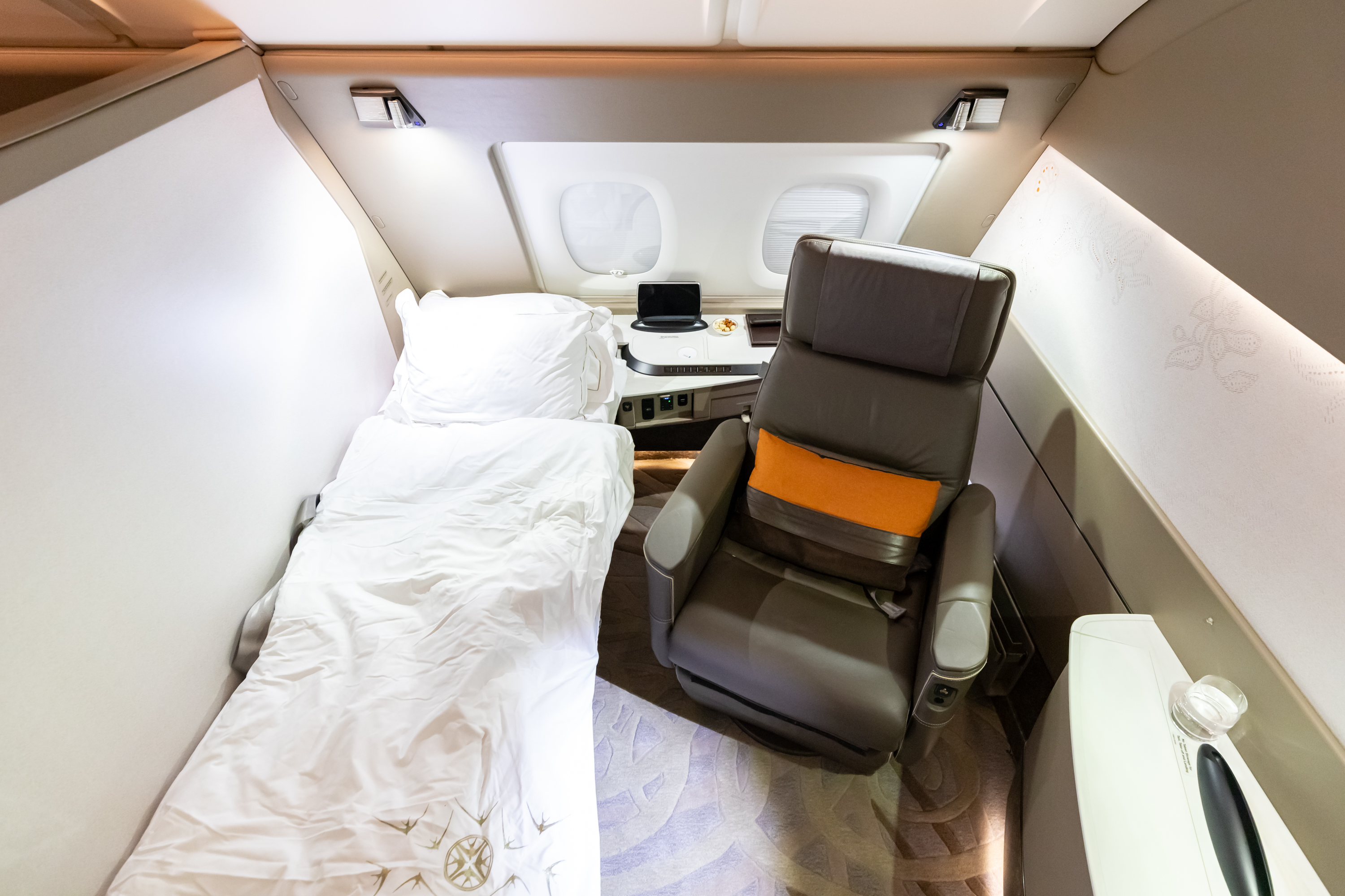 a chair and a bed in a plane