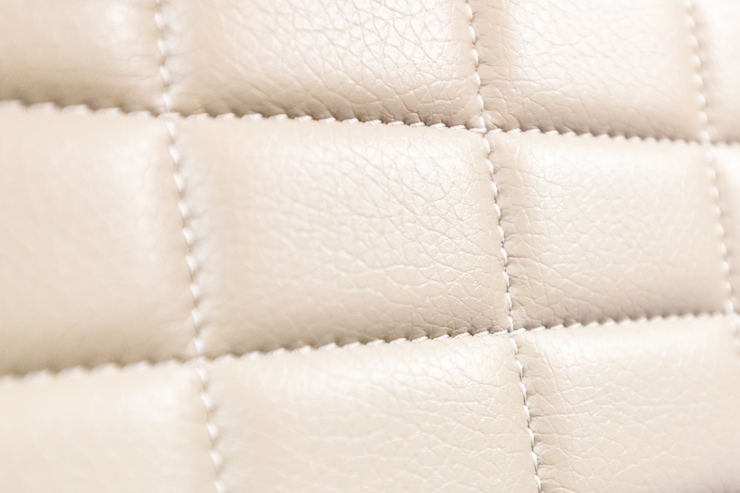 a close up of a white leather surface