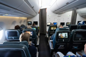 a group of people sitting in chairs with monitors on the back