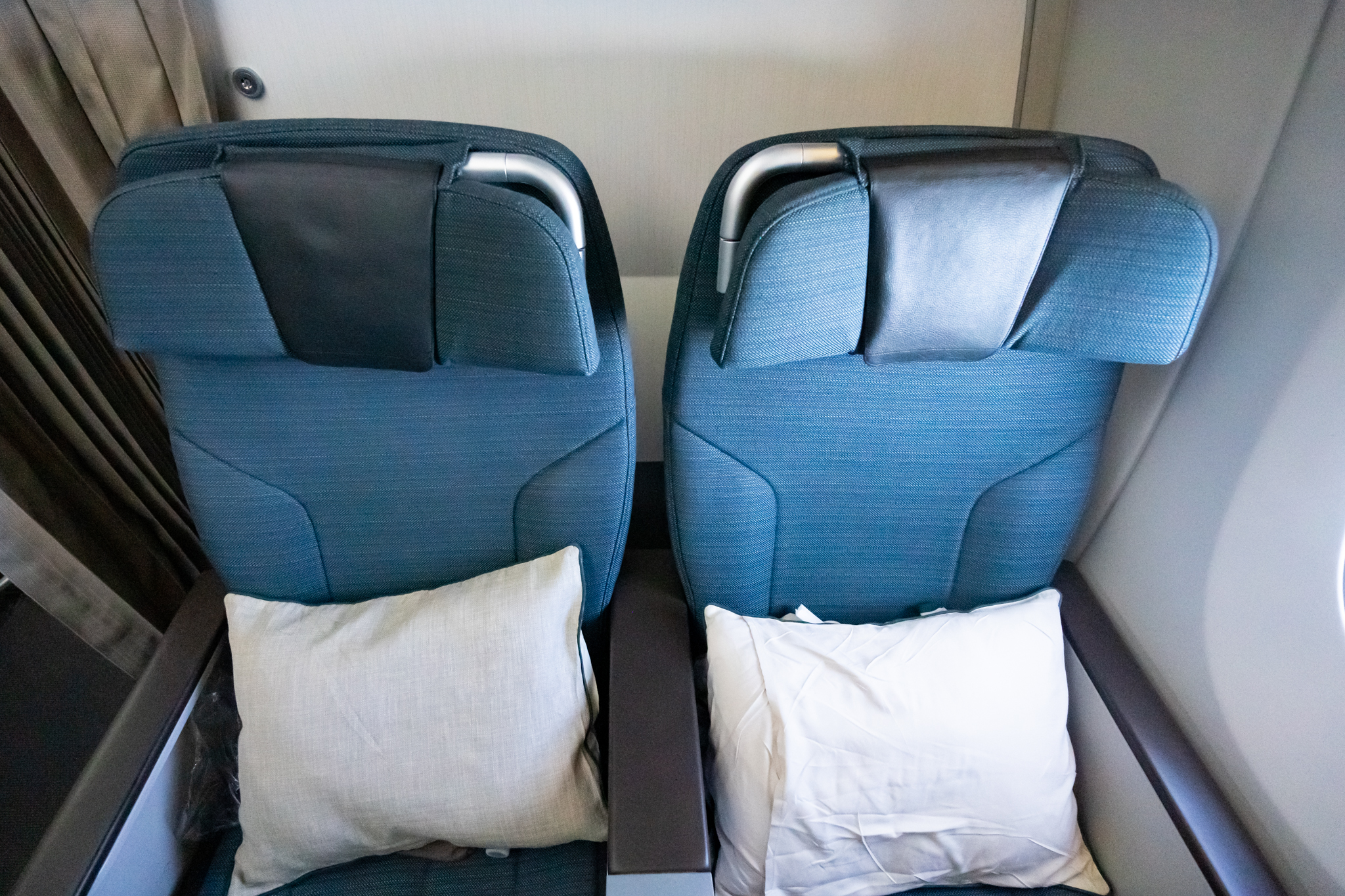 two seats with pillows on the side