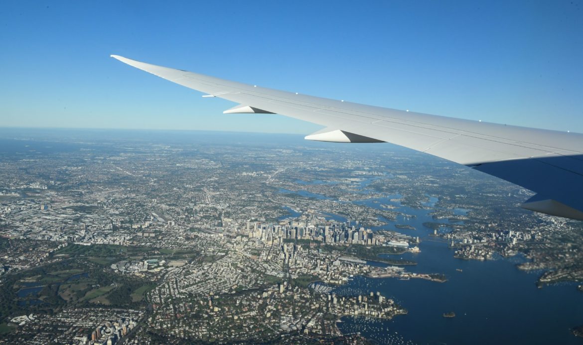 an airplane wing above a city