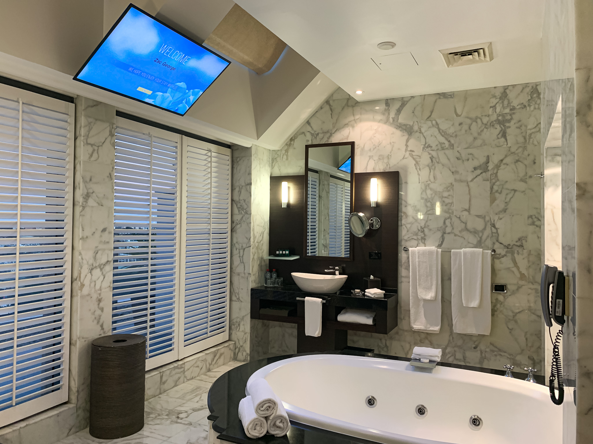 a bathroom with a tv and a tub