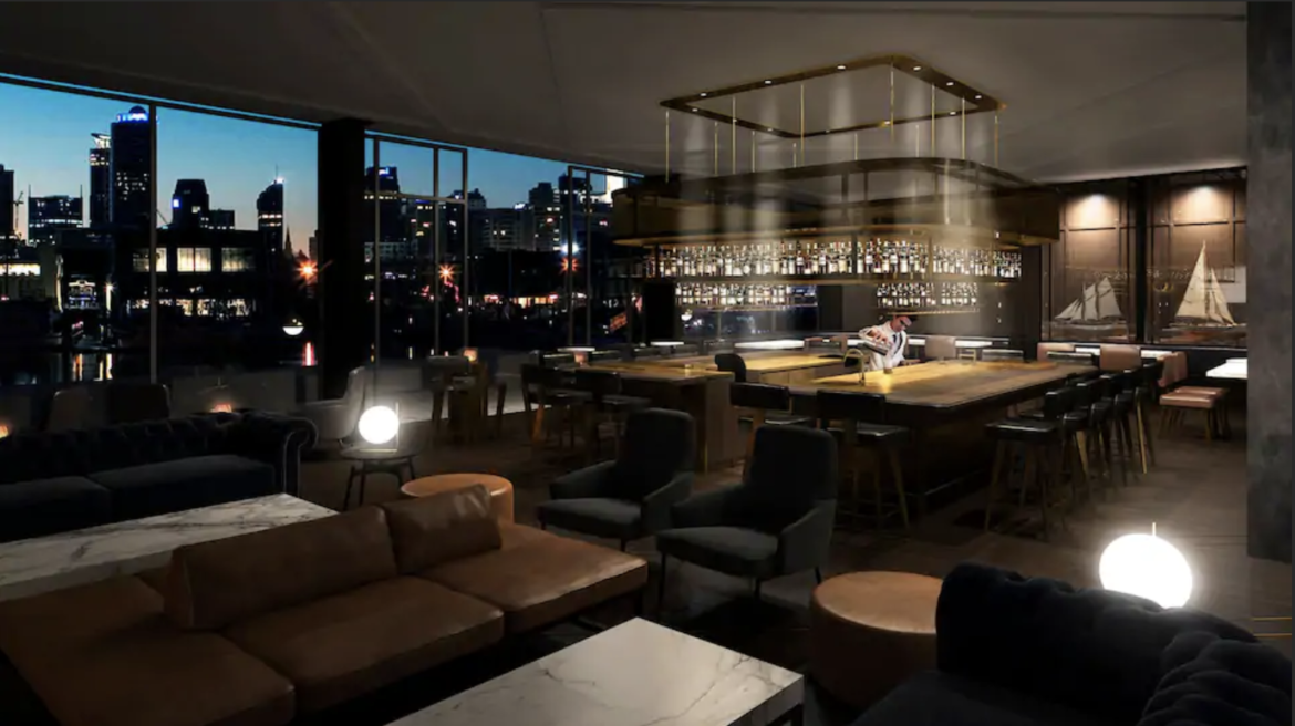 a room with a bar and a man sitting at a bar