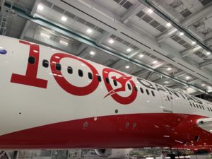 a large white and red airplane in a swinger