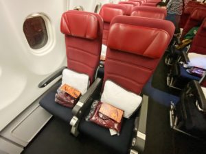 a row of red seats on an airplane