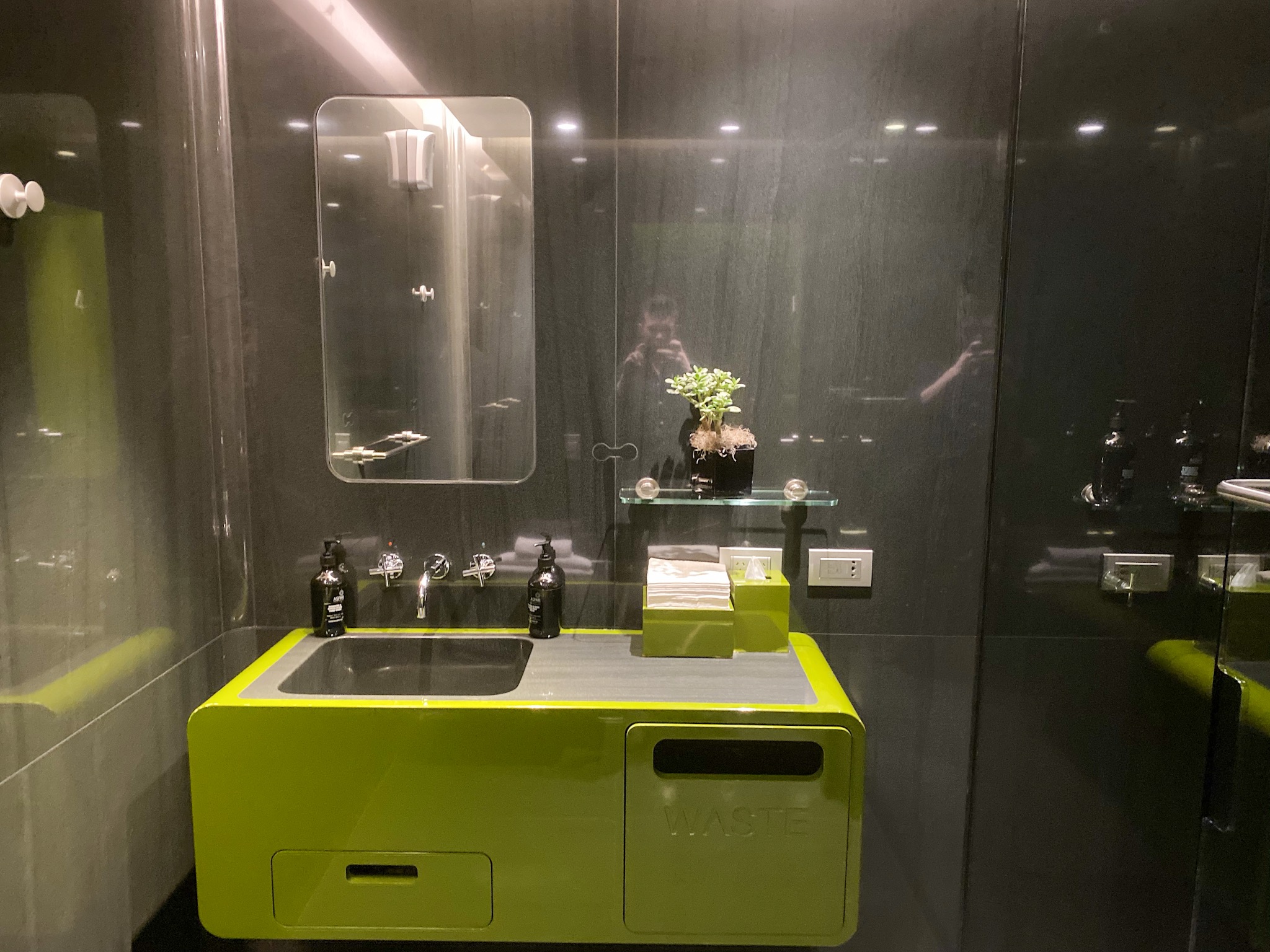 a bathroom with a green sink and a mirror