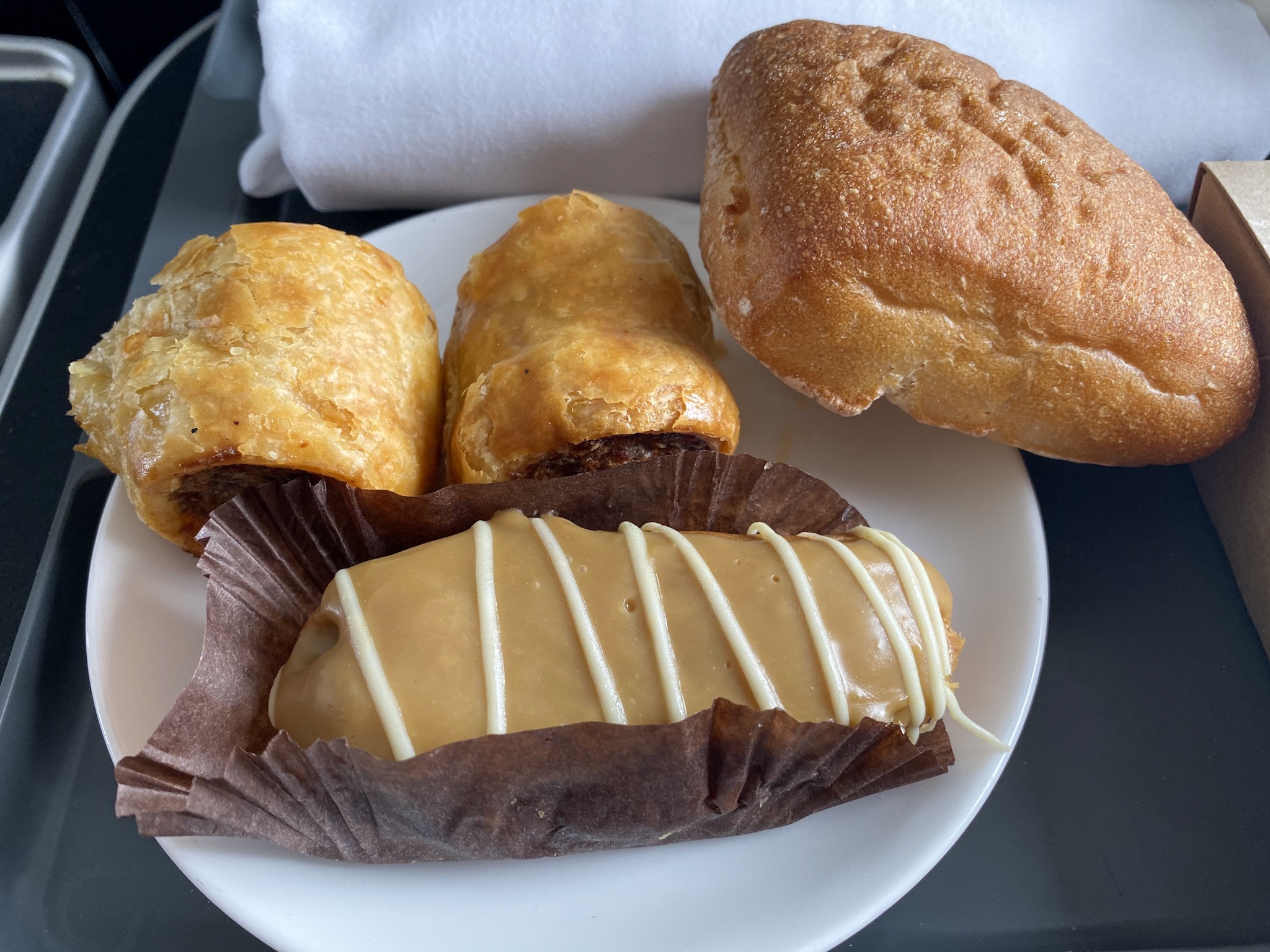 a plate of pastries and rolls