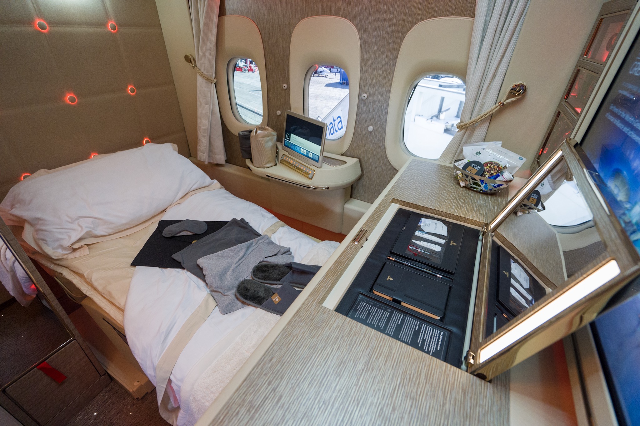 a bed with a desk and windows in a plane