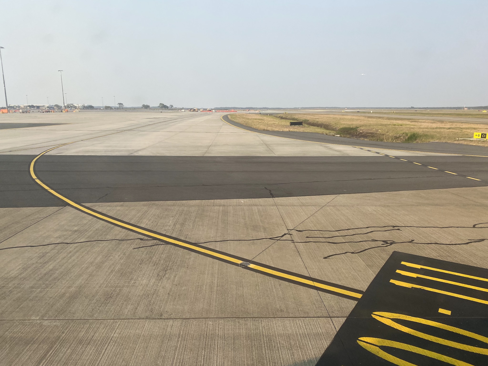 a runway with yellow lines on it