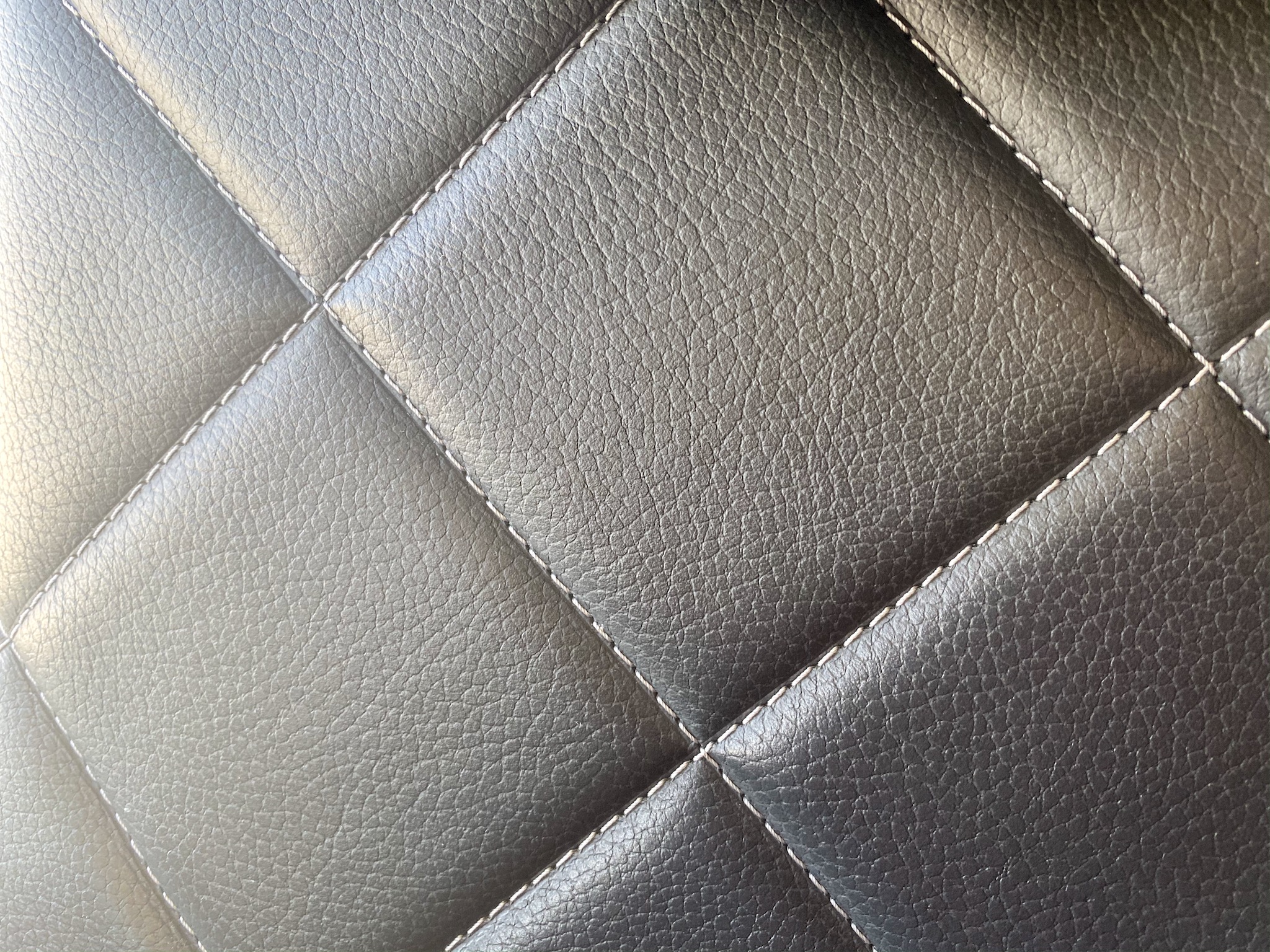 a close up of a black leather surface
