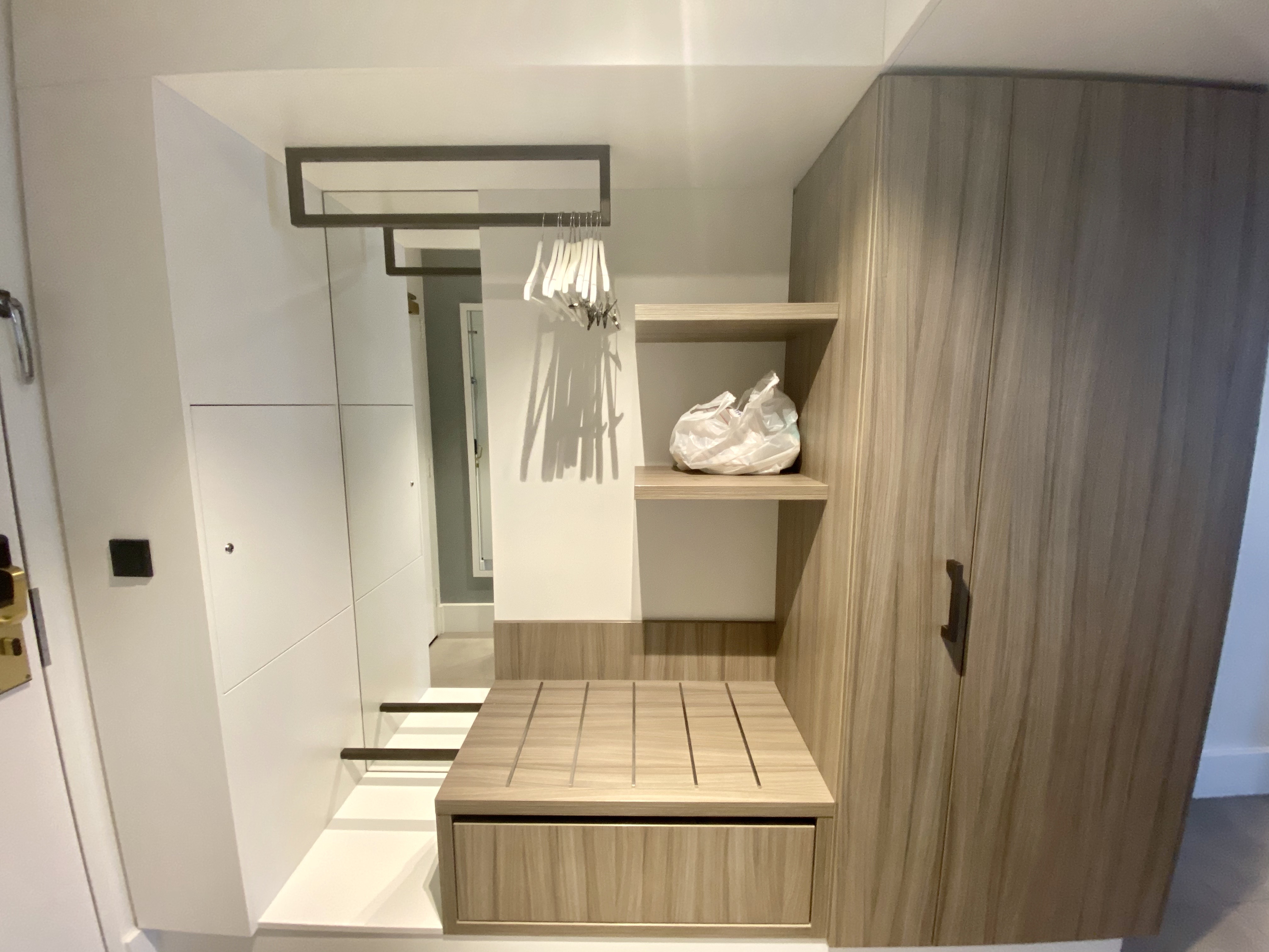 a closet with a shelf and swinger