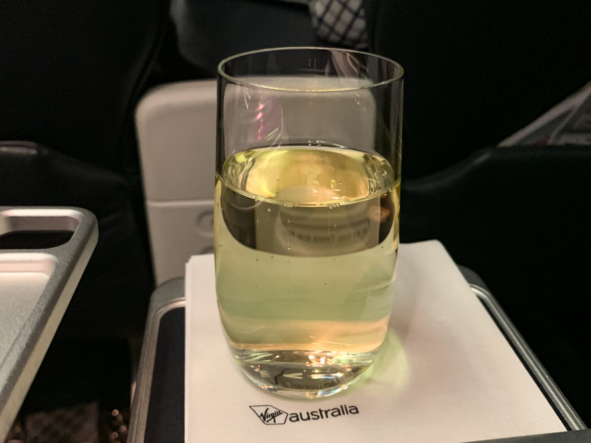 a glass of liquid on a napkin