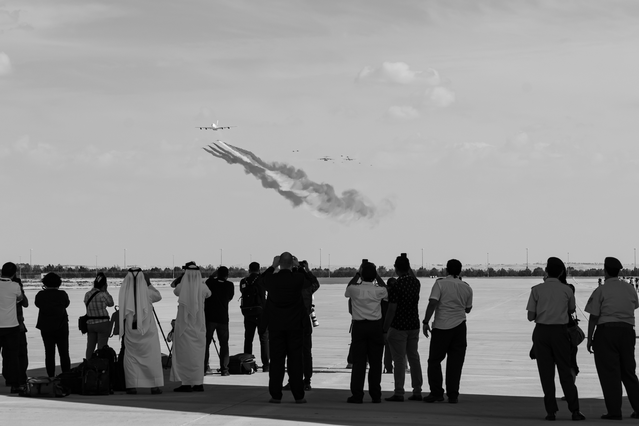 a group of people watching airplanes flying in the sky