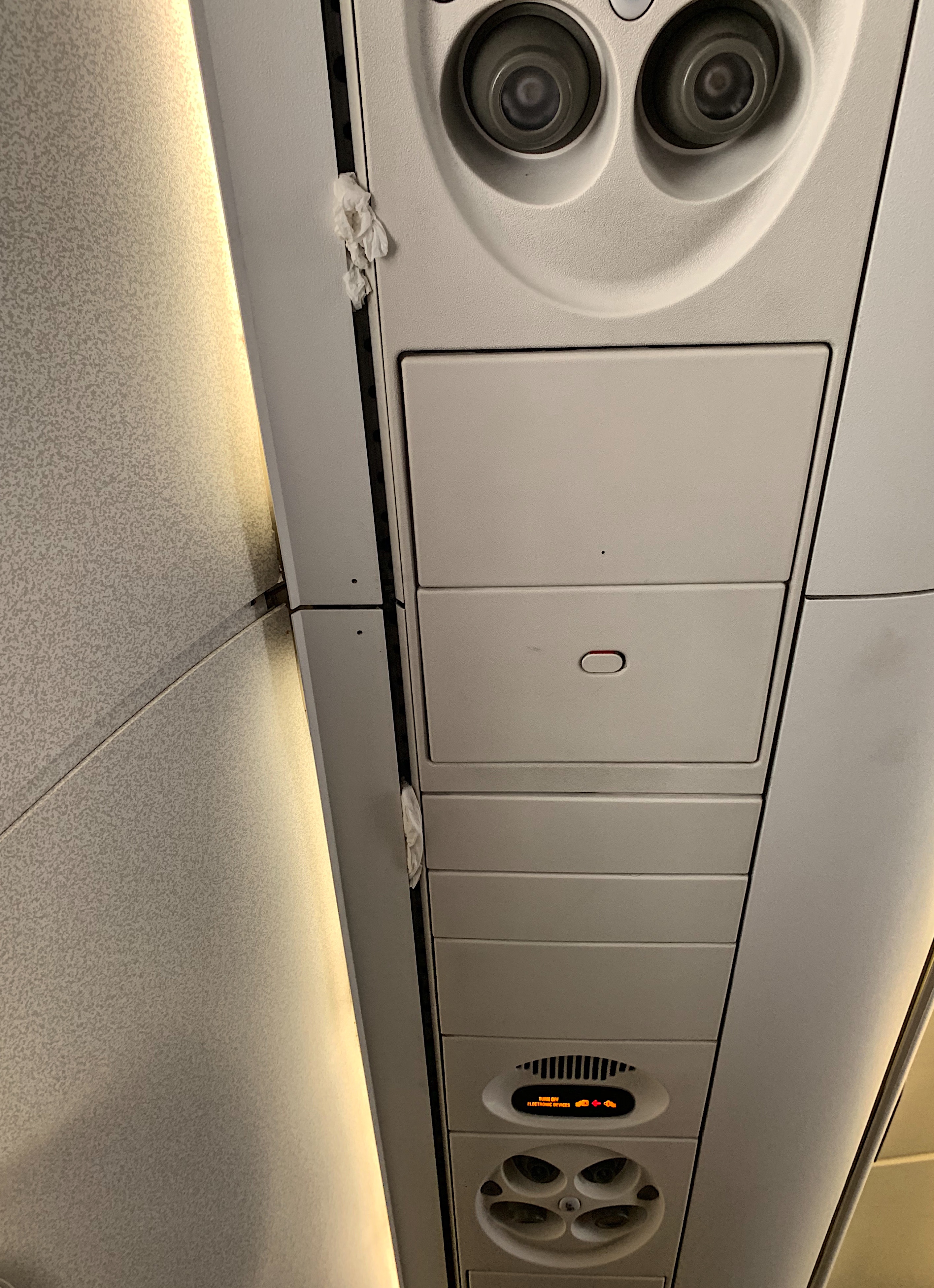 a ceiling with a vent and a speaker