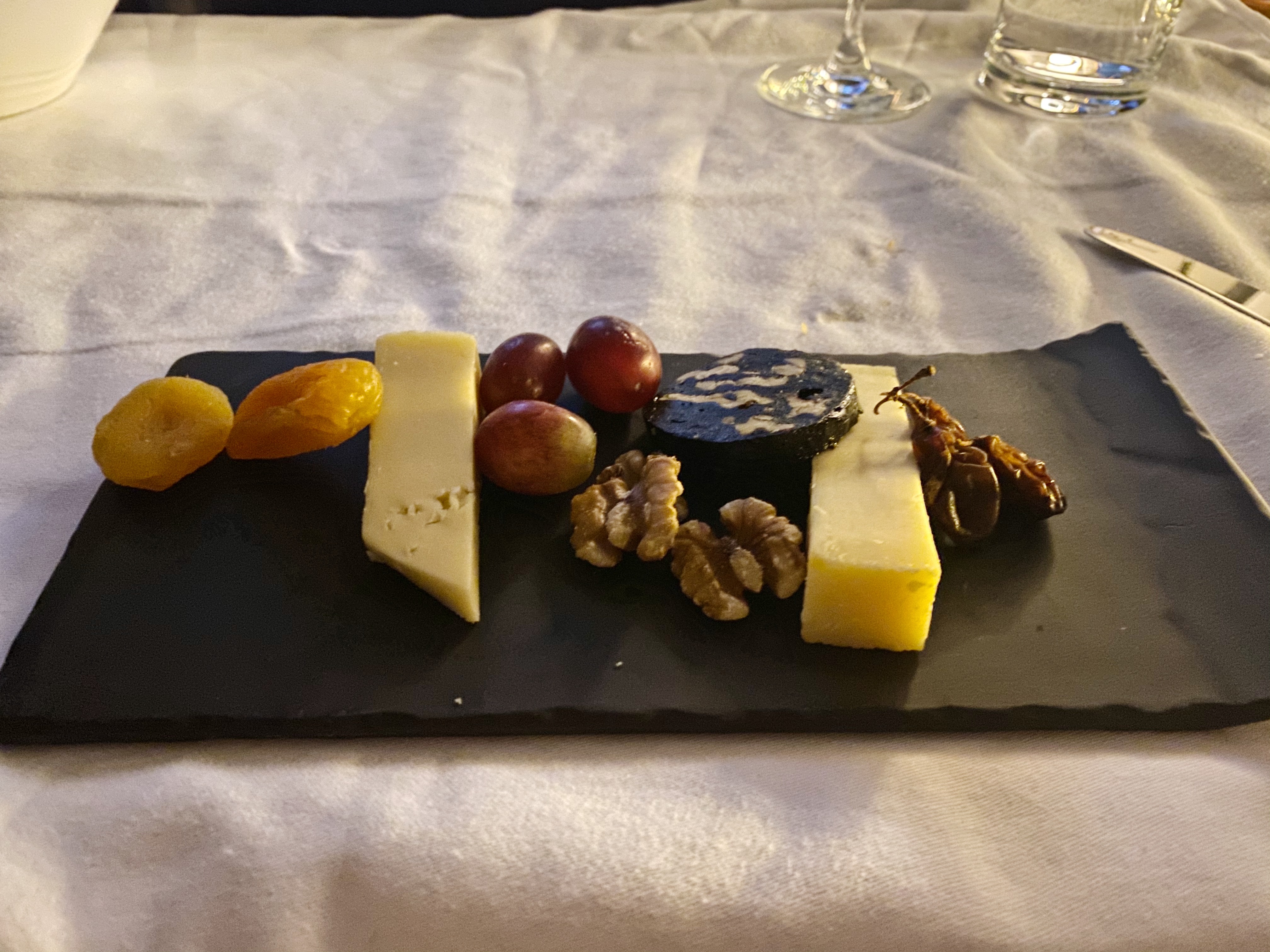 a plate of cheese and fruit
