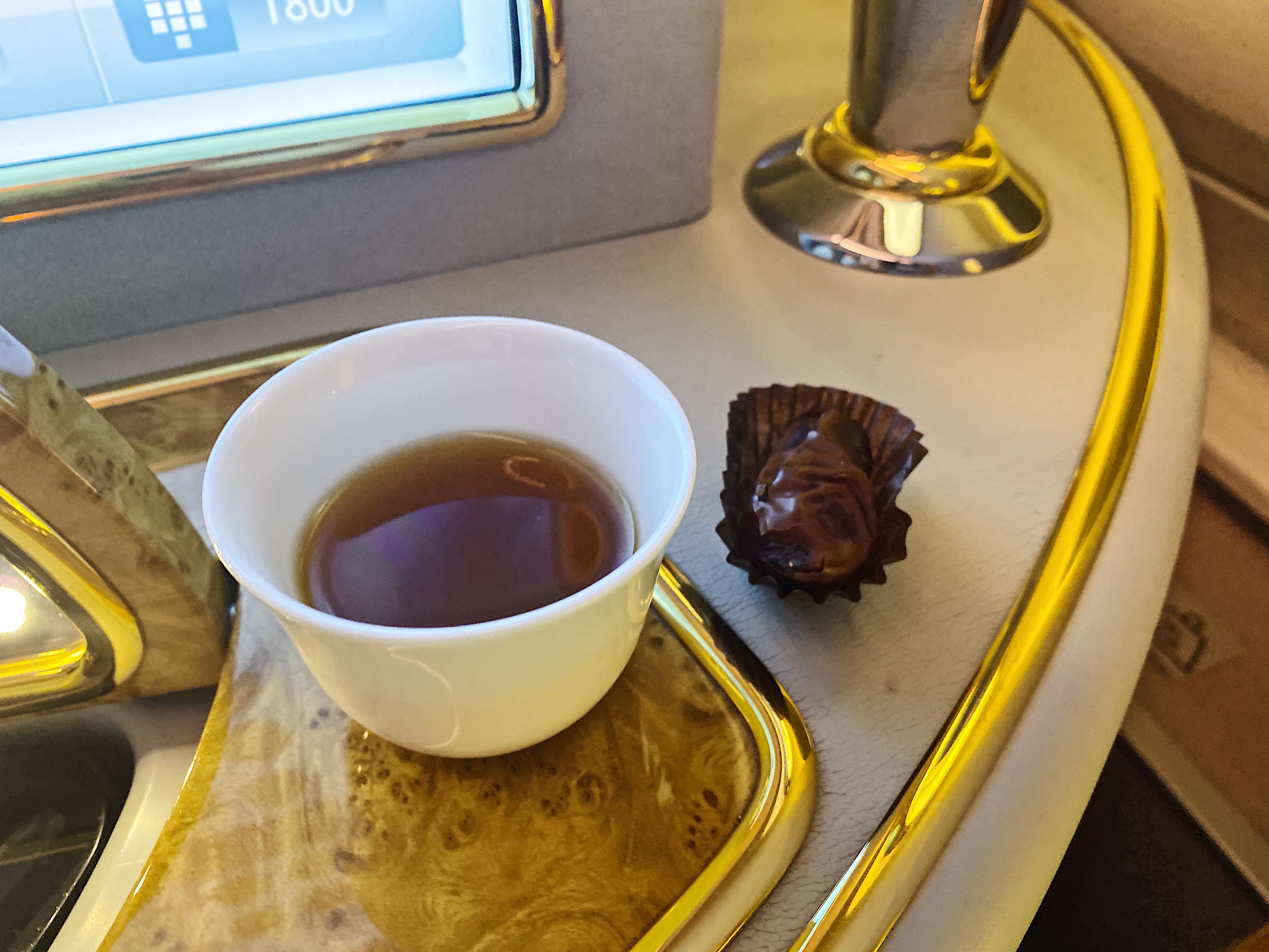 a cup of tea and chocolate on a tray