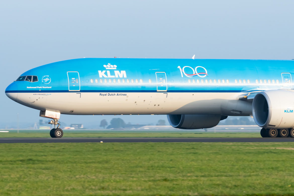 a blue and white airplane taking off