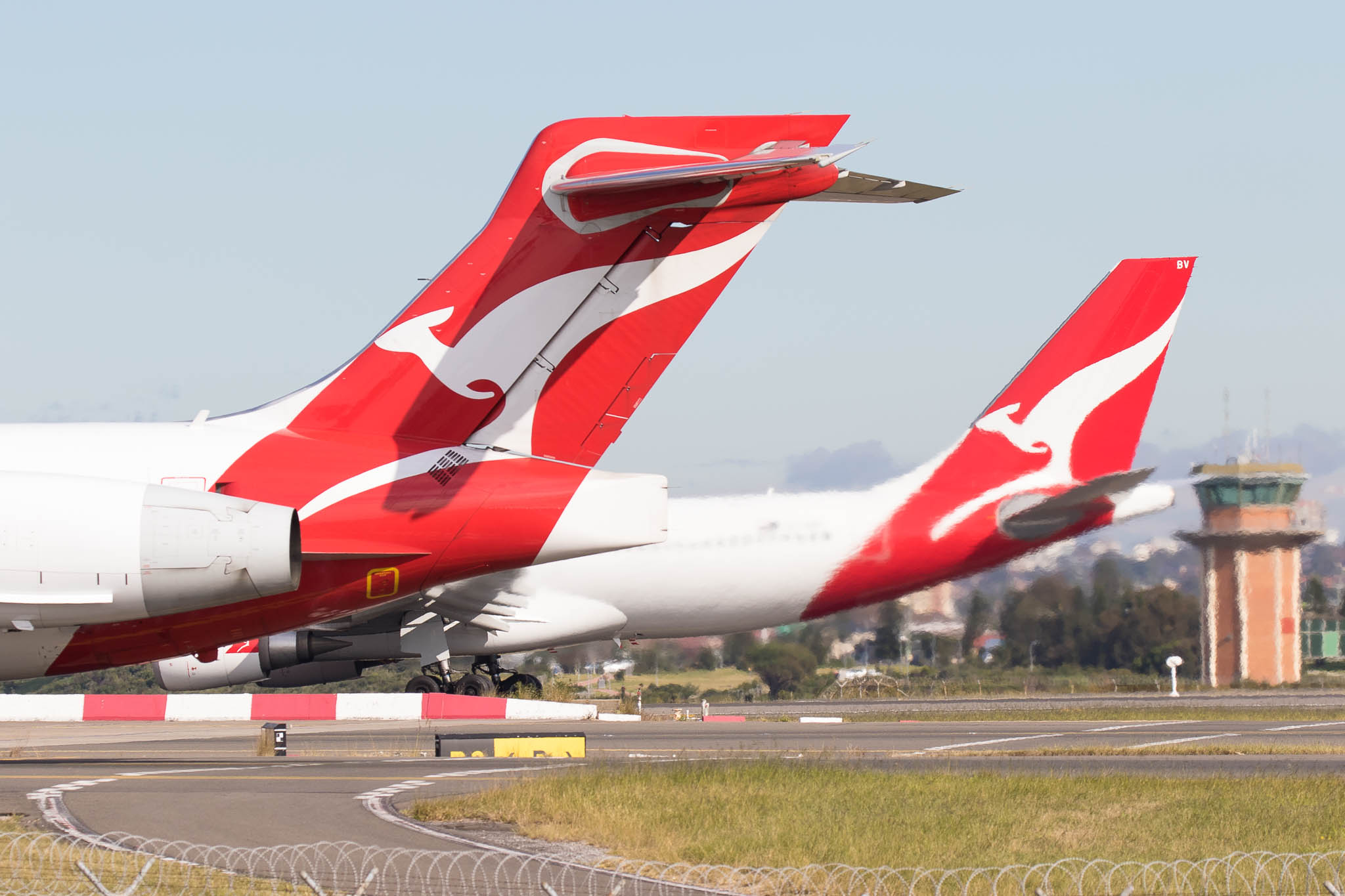 a red and white airplane on a runway
