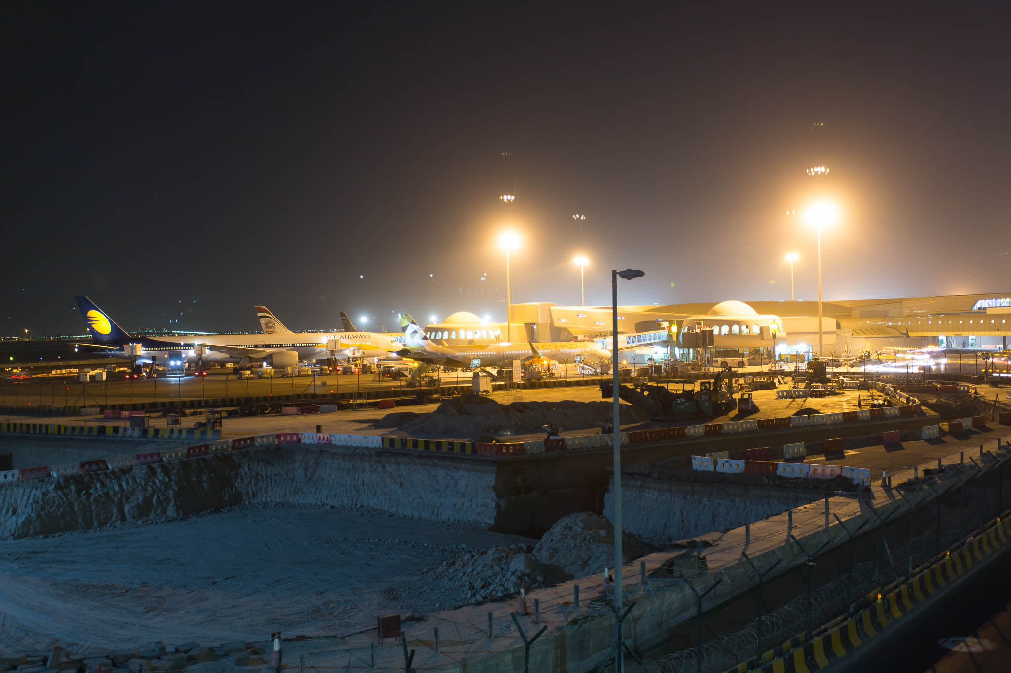 an airport with airplanes at night