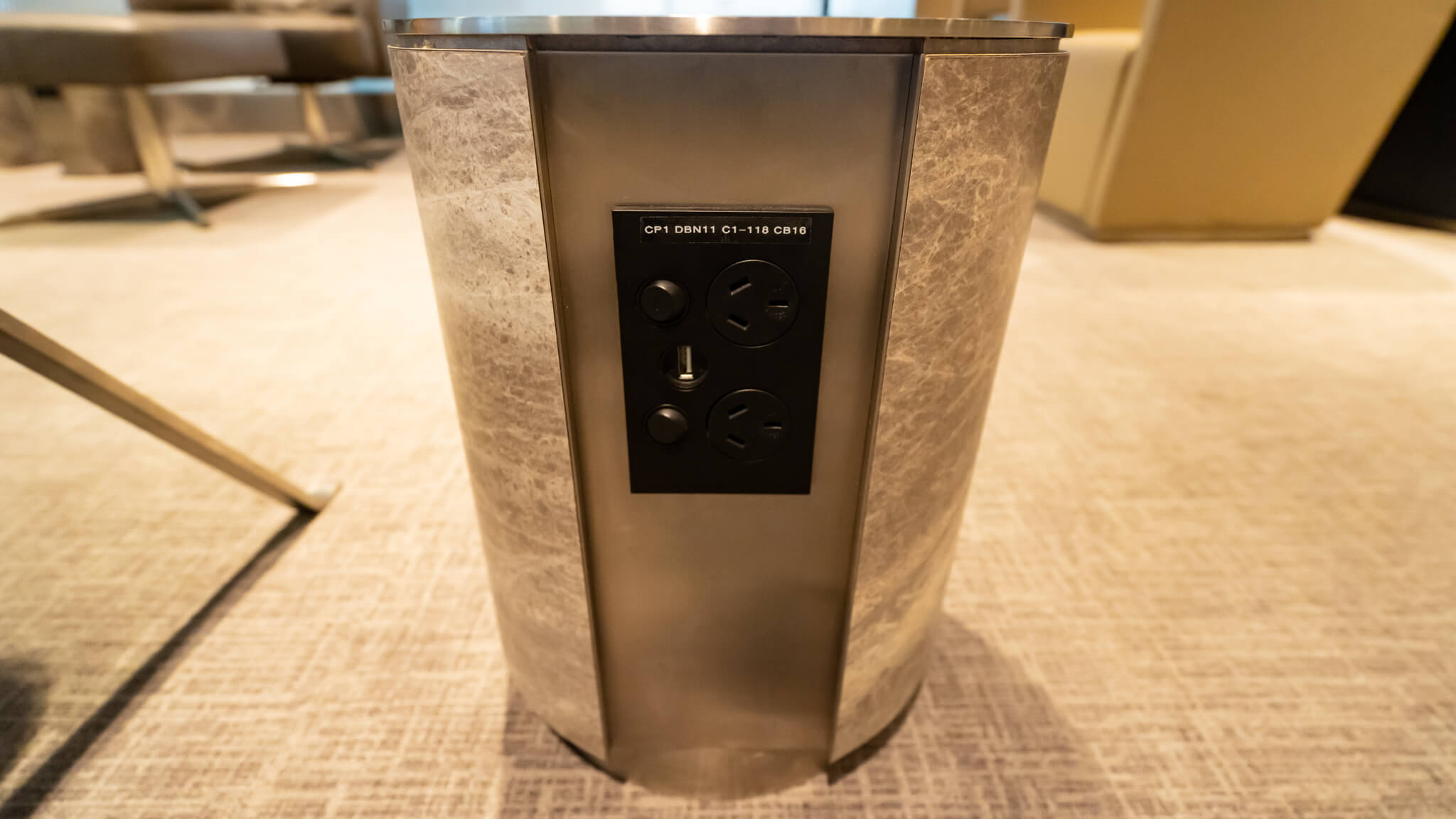 a silver cylinder with a black panel