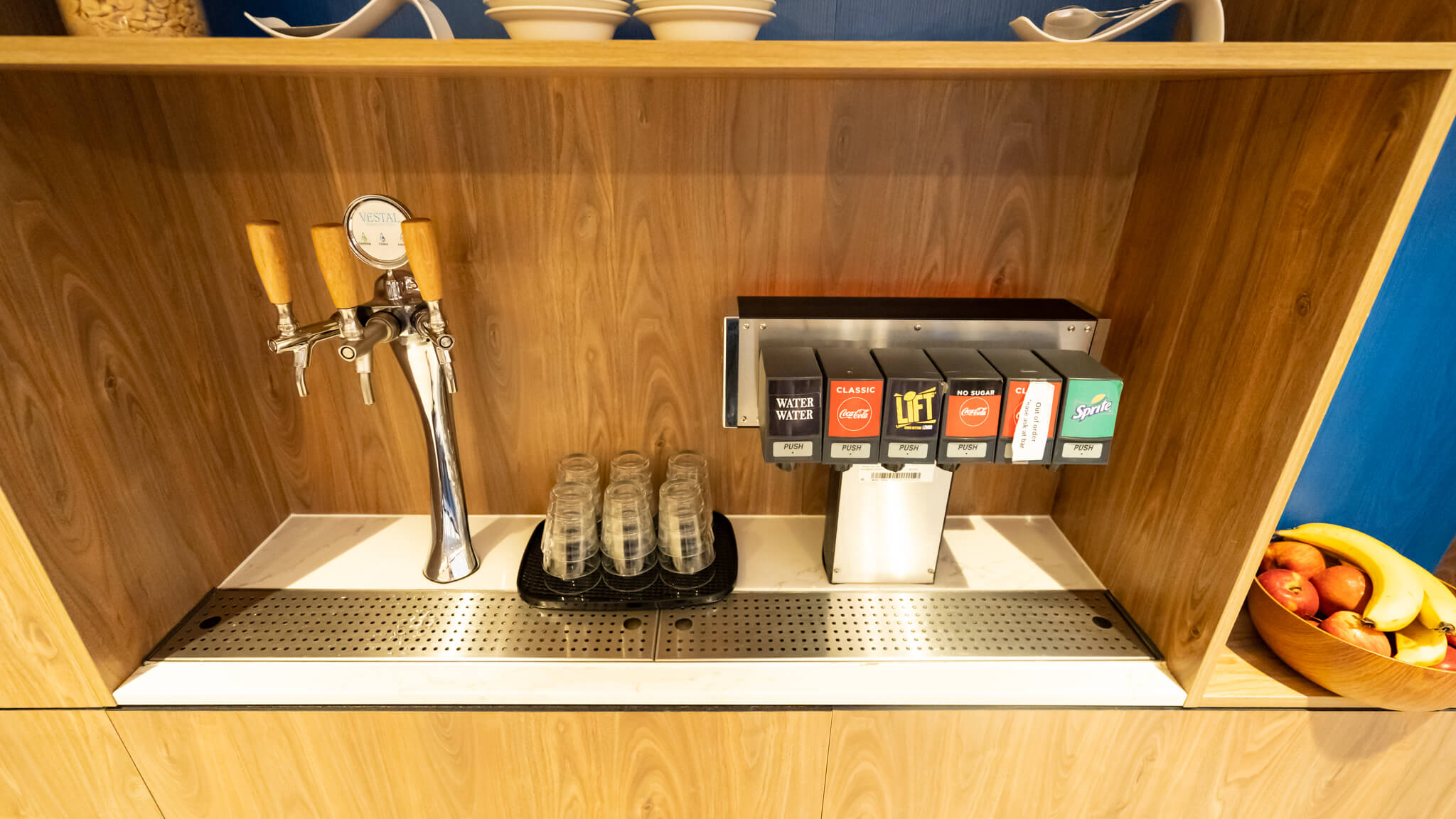 a dispenser and a drink dispenser on a counter