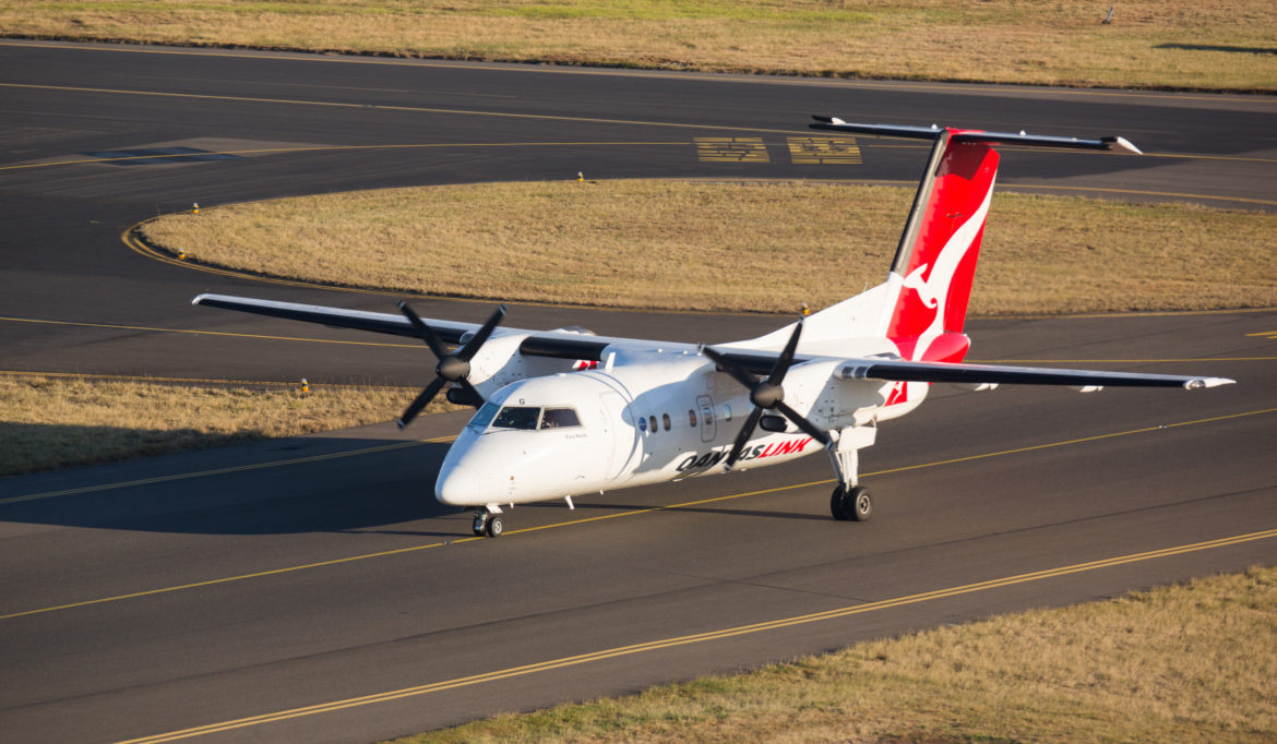 a white airplane on a runway