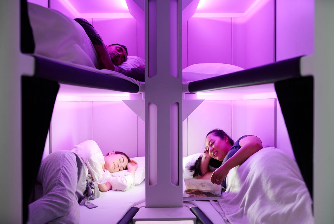 a group of people sleeping in a bunk bed