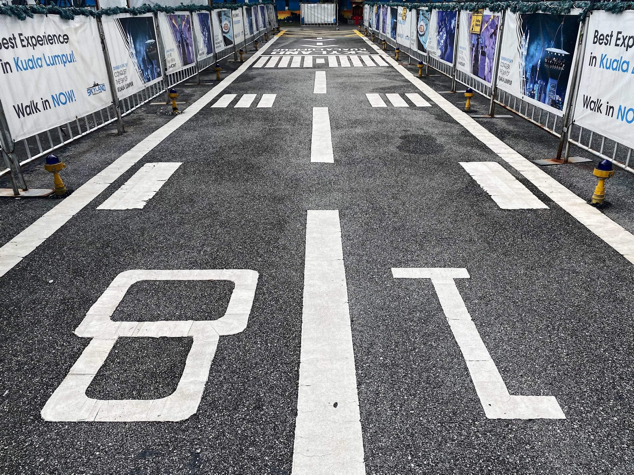 a road with white lines and white text on it