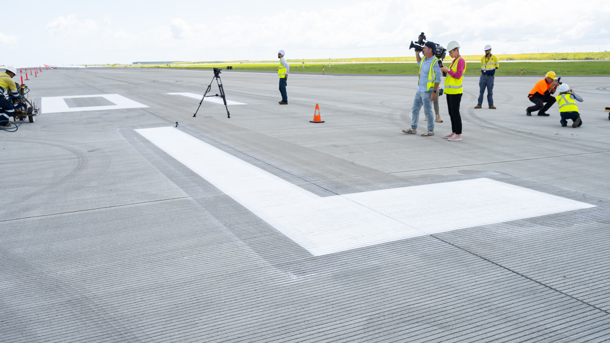 a group of people standing on a runway