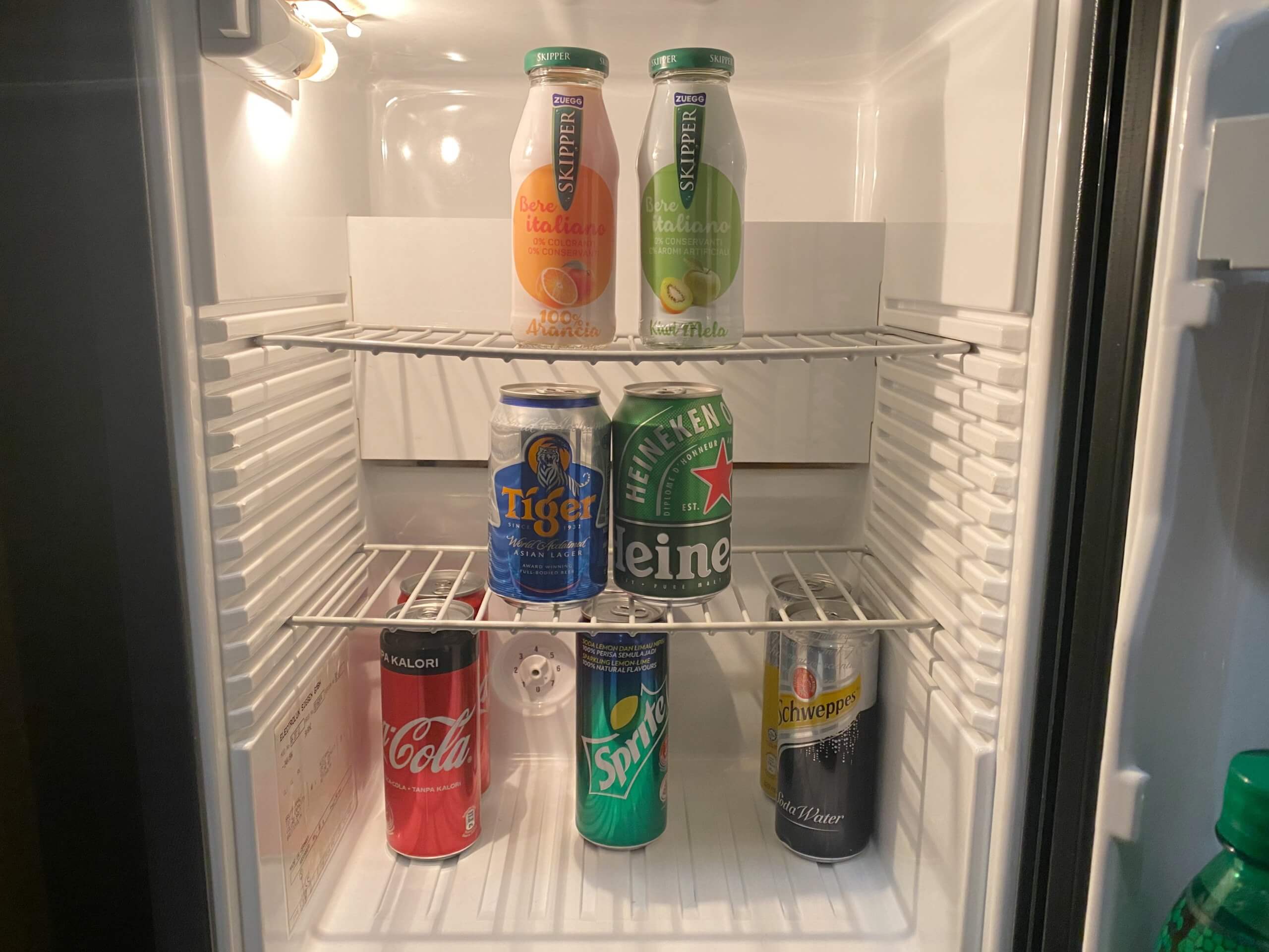 a refrigerator with cans of soda and other beverages