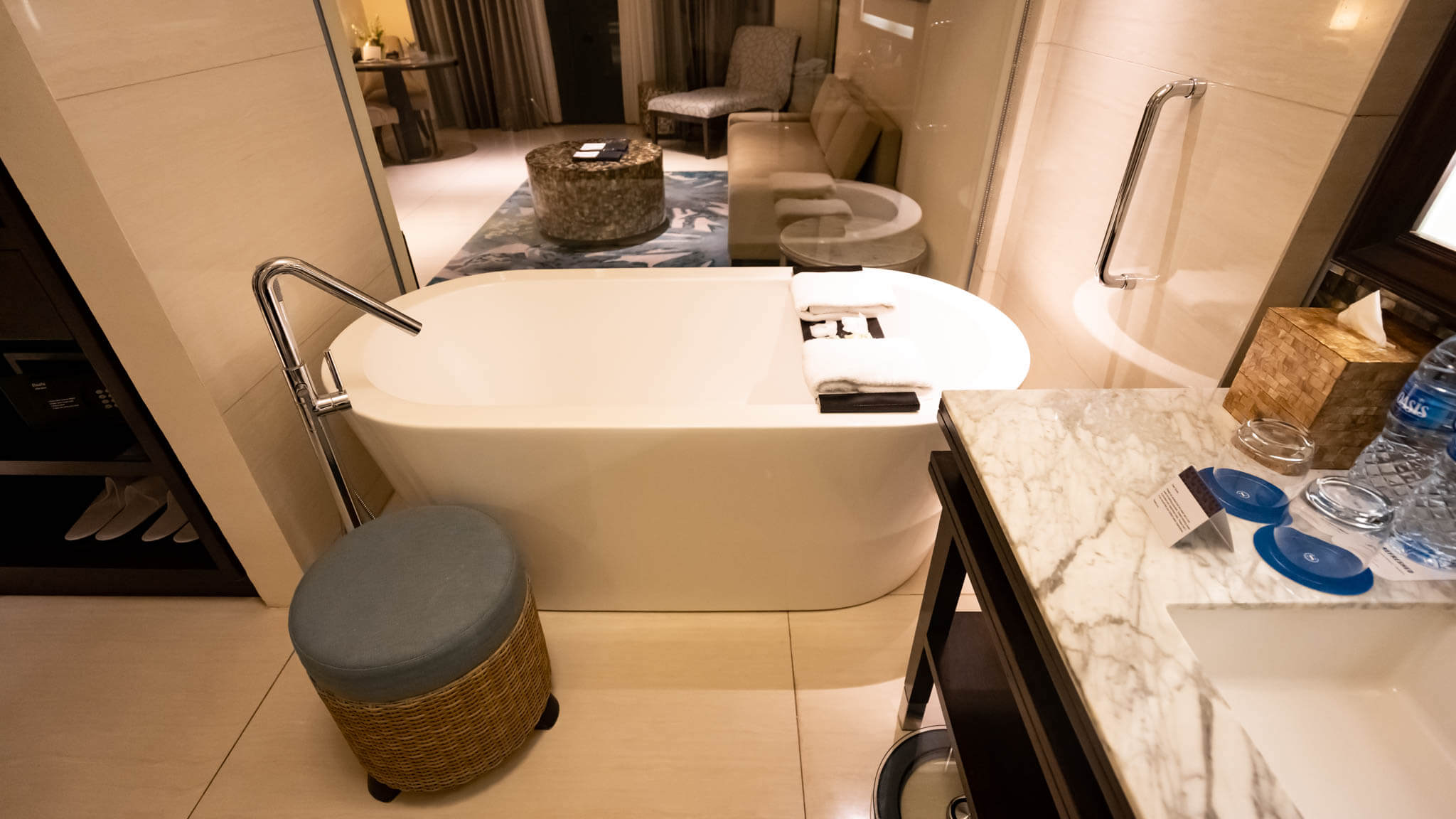a bathroom with a tub and a stool