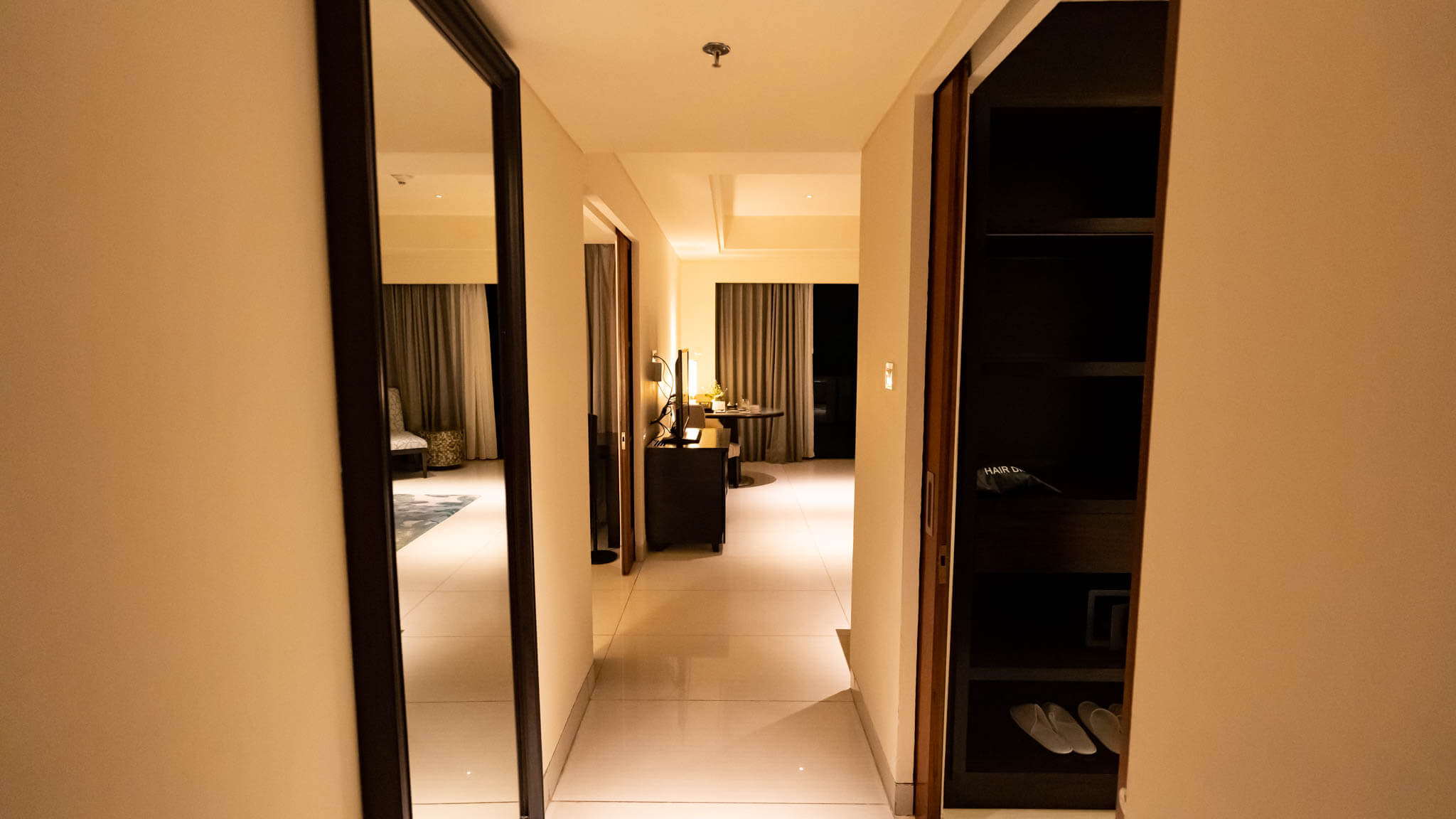 a hallway with a mirror and a desk