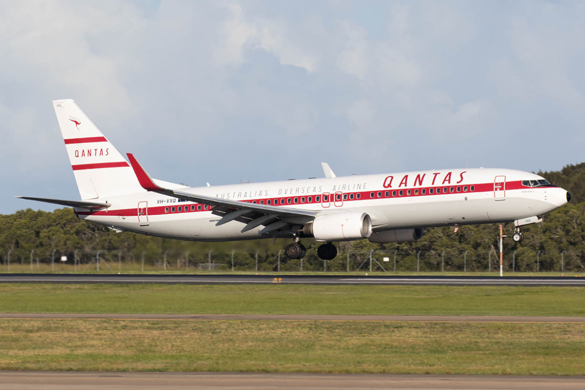 a white and red airplane taking off