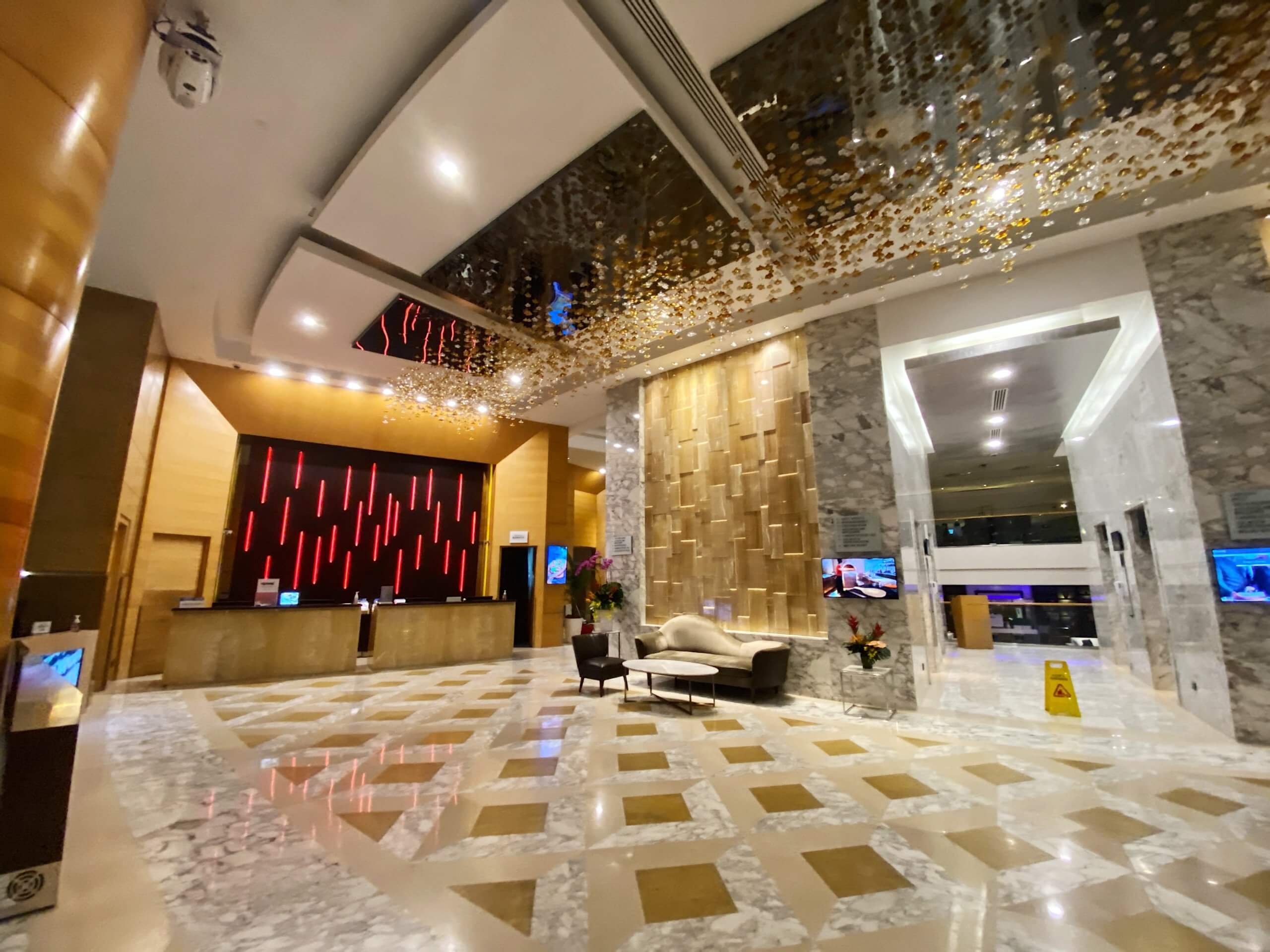 a lobby with a reception desk and a mirror ceiling