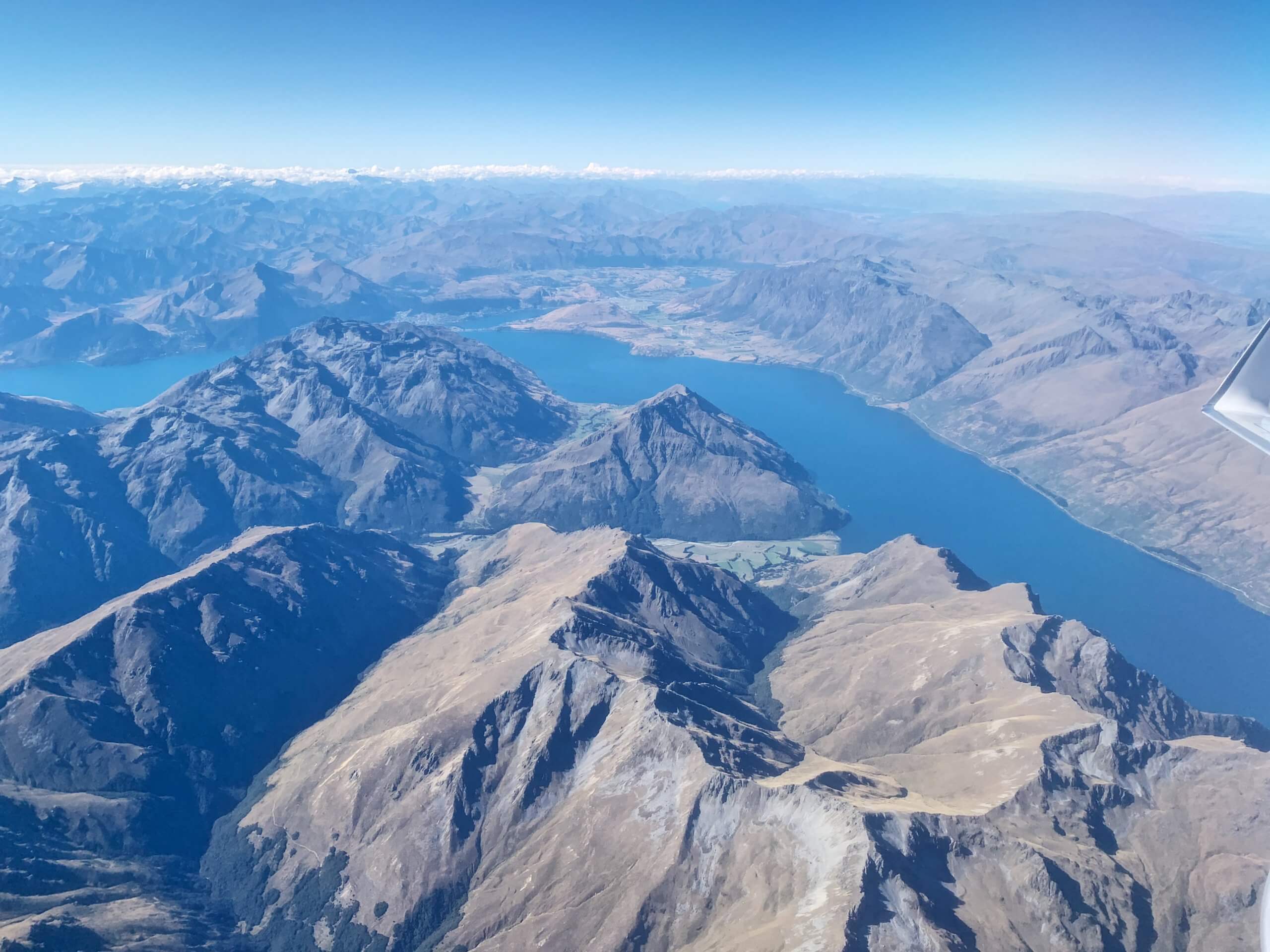 a aerial view of a lake and mountains
