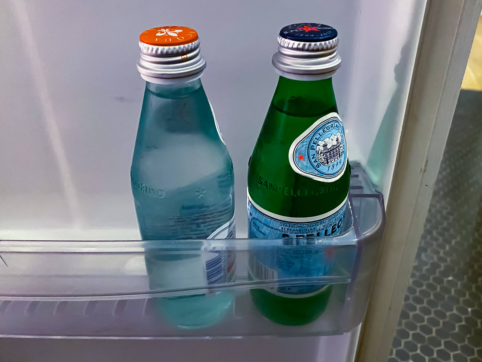 two bottles in a refrigerator