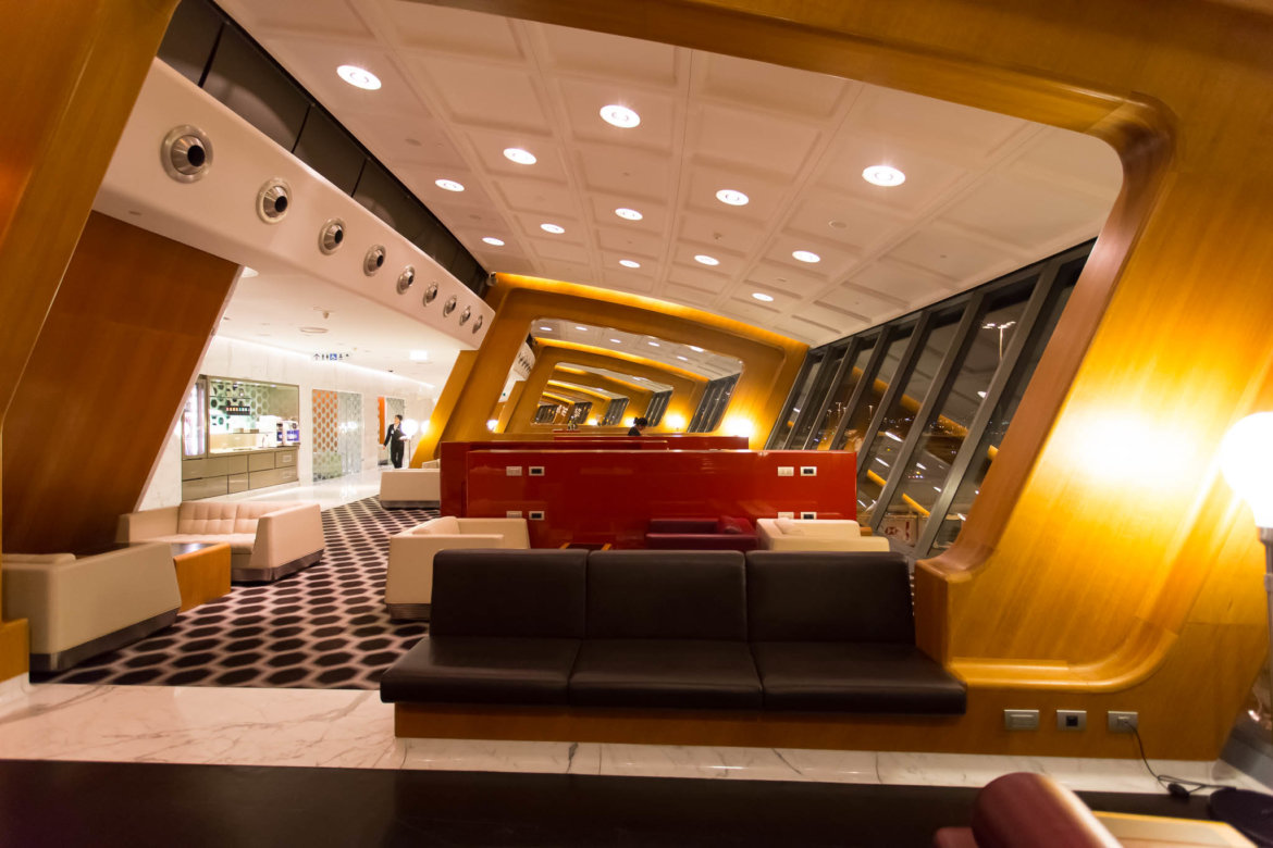 a room with a couch and a red wall