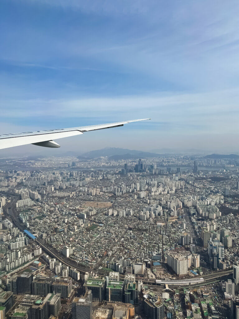 an airplane wing and city